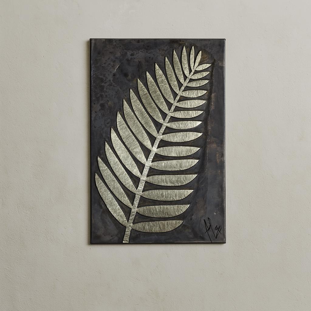 a large, metallic leaf design on a dark background.