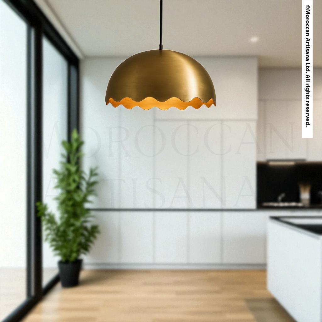 a modern kitchen with a large potted plant and a hanging gold-colored pendant light.