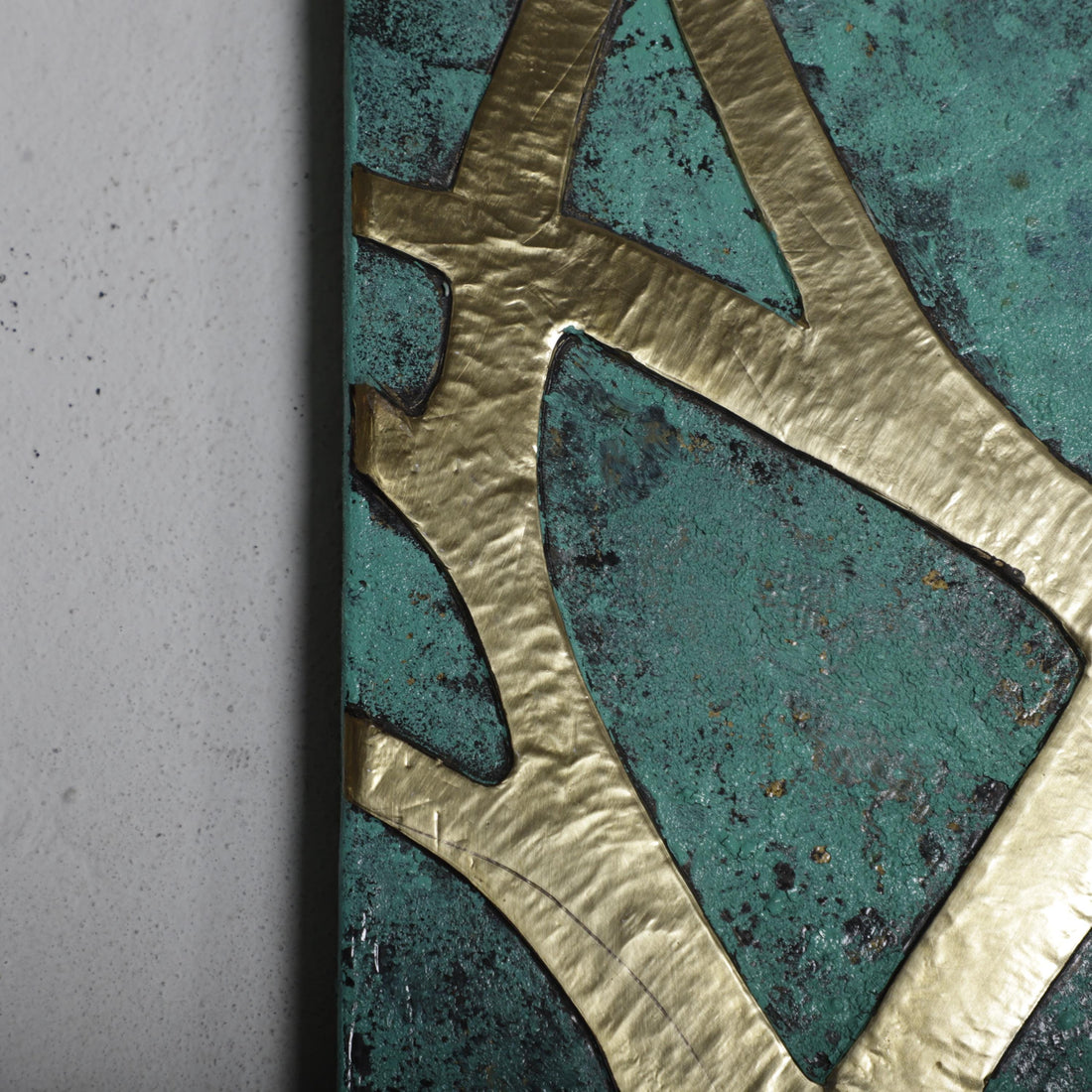 a close-up view of a textured surface with a metallic gold design.