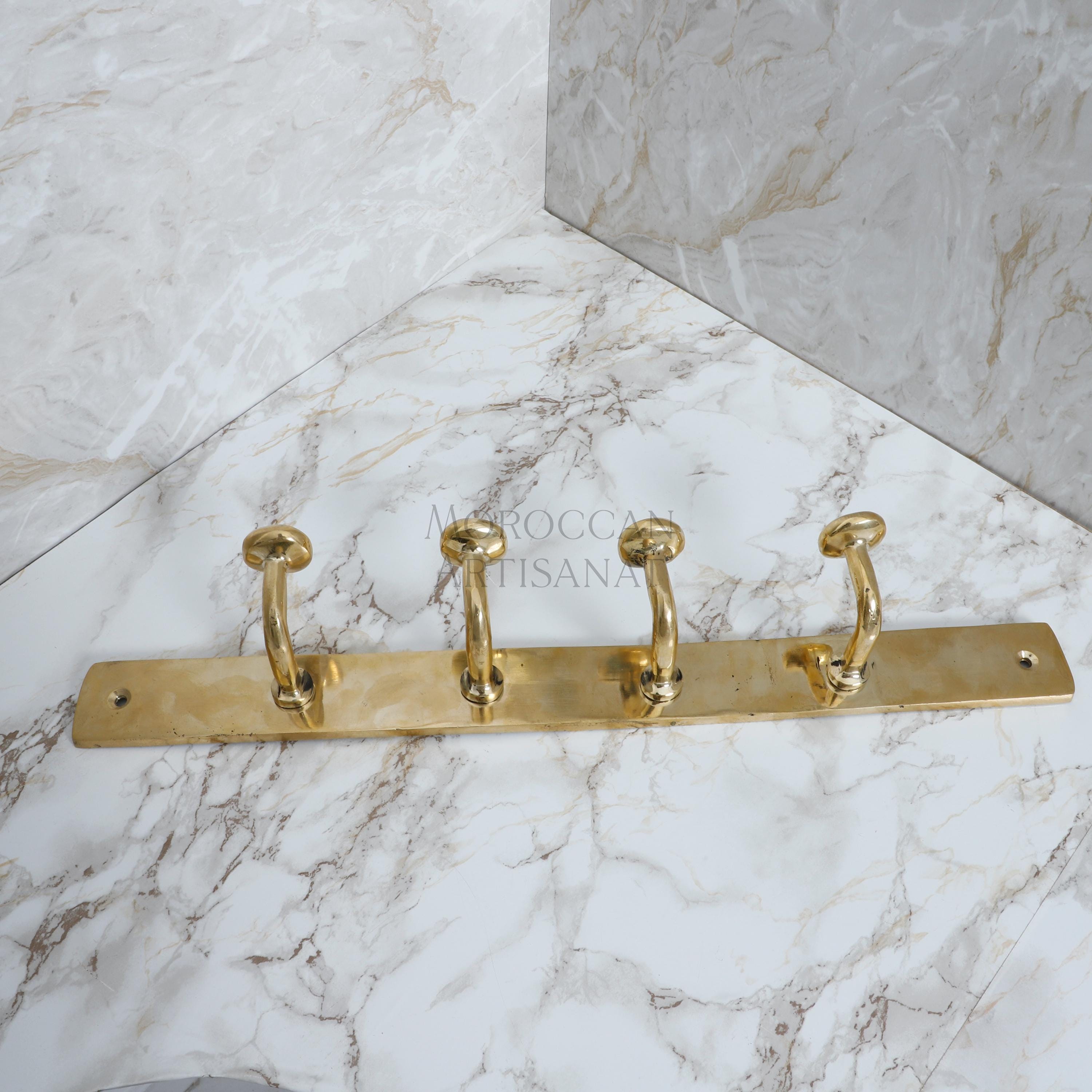 a marble counter top with three brass handles