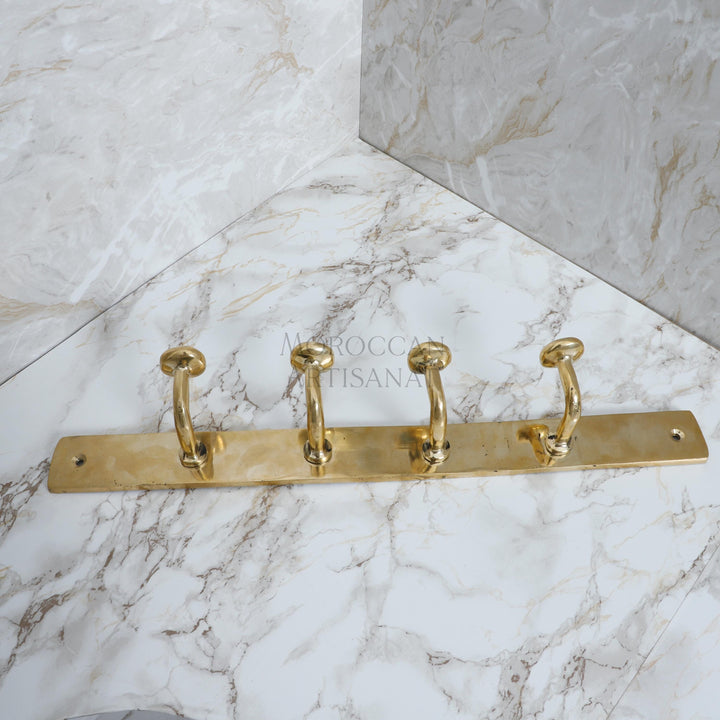 a marble counter top with three brass handles