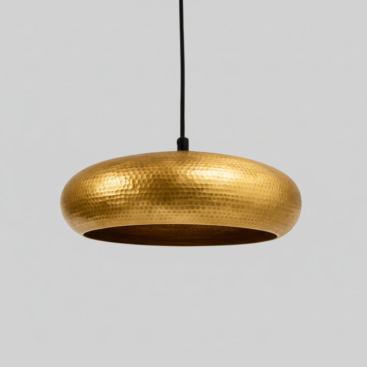 A gold-colored pendant light fixture hangs from the ceiling, casting a warm glow in the room.