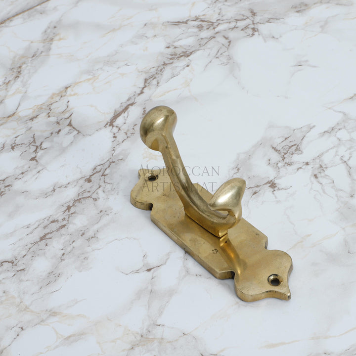 a golden door handle on a marble surface