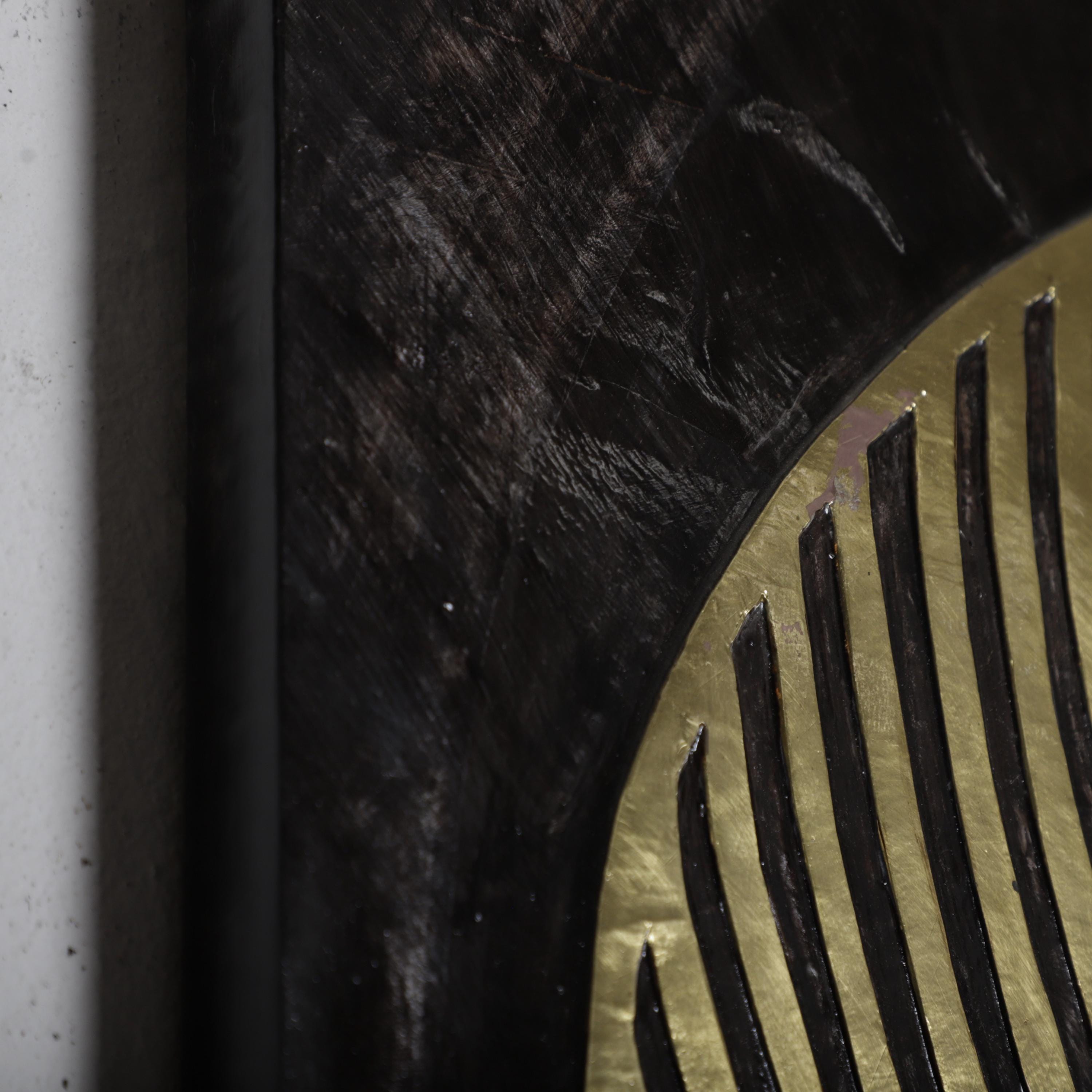 a close-up view of a dark, textured surface with a metallic, gold-colored element.