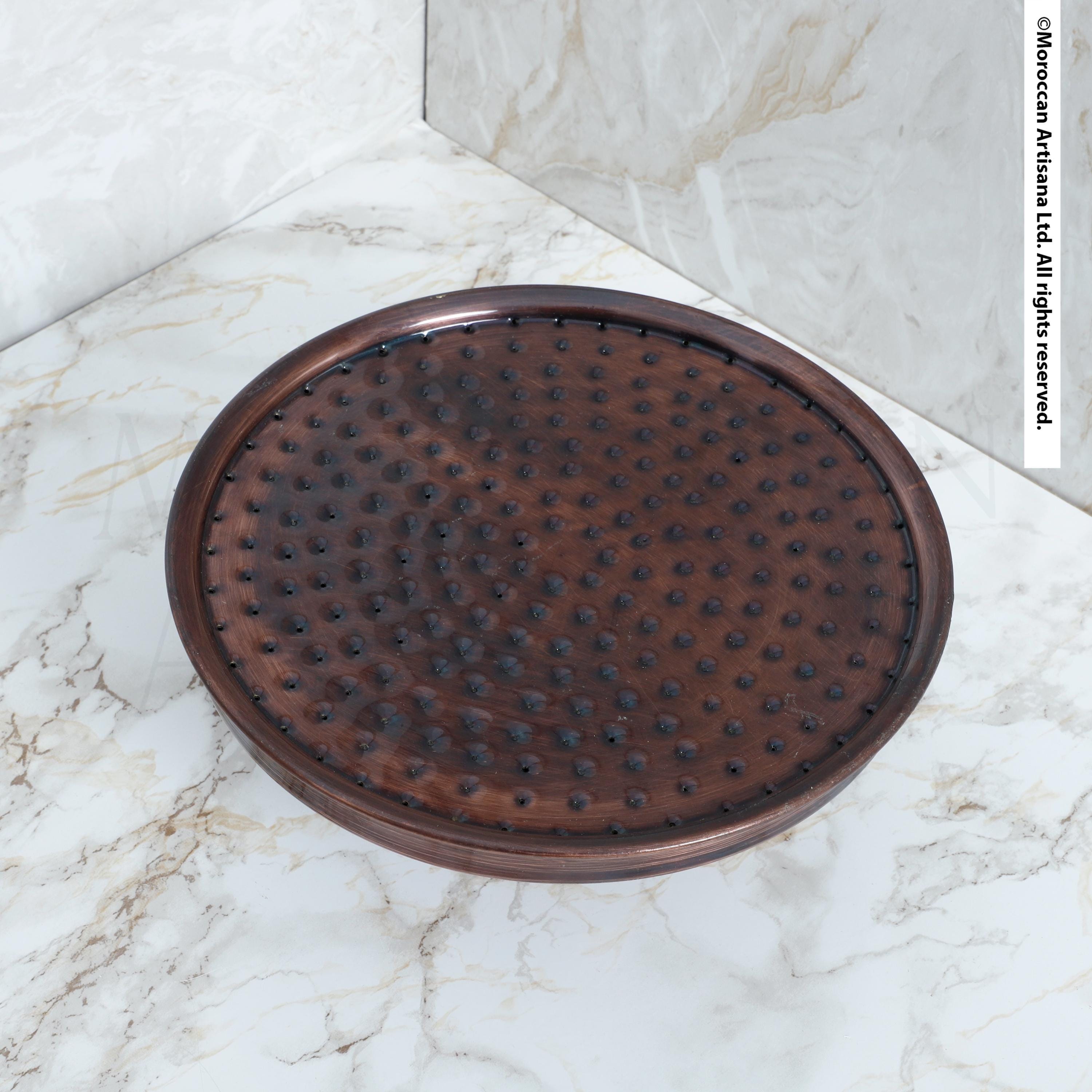 a round, brown object with a textured surface, placed on a white marble countertop.