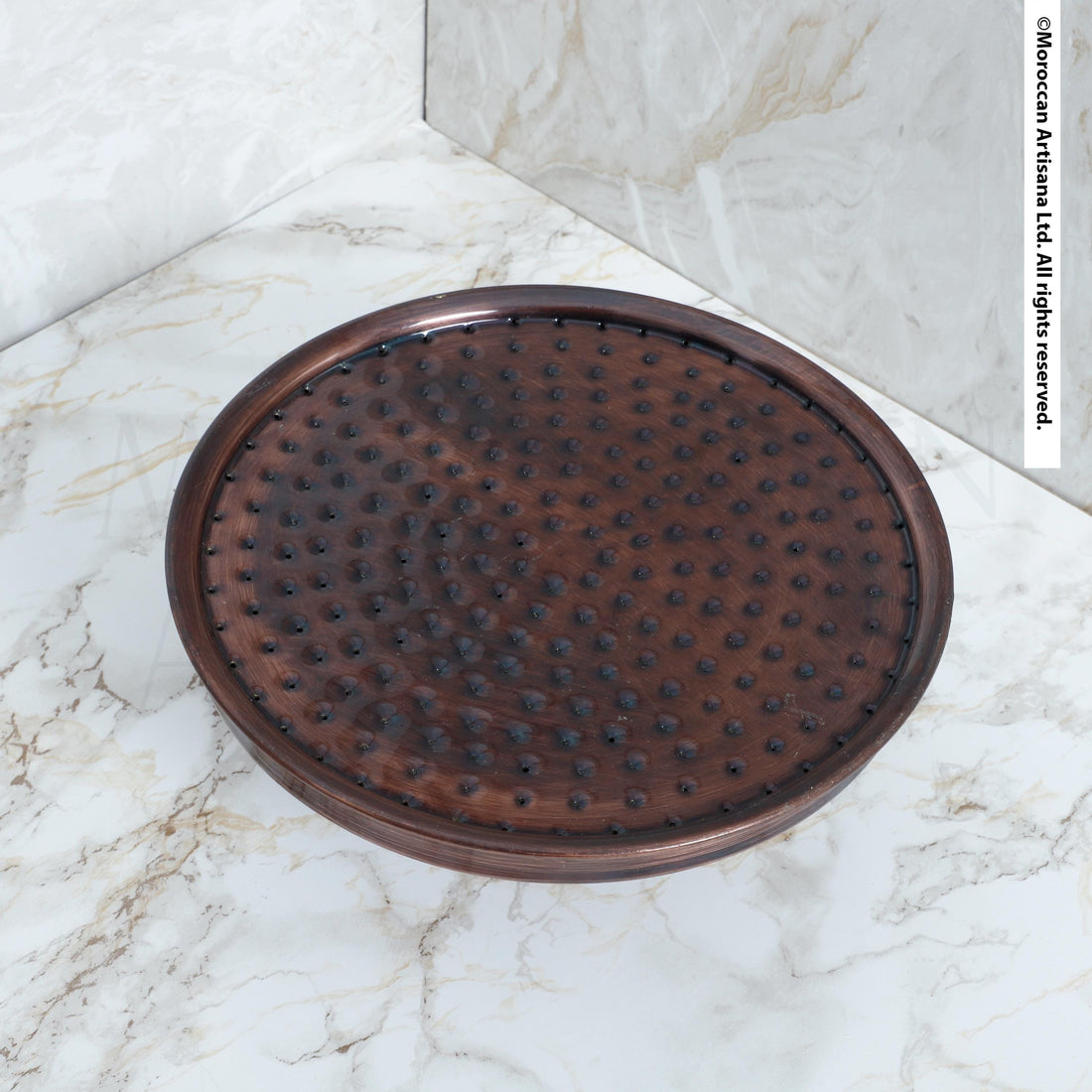 a round, brown object with a textured surface, placed on a white marble countertop.