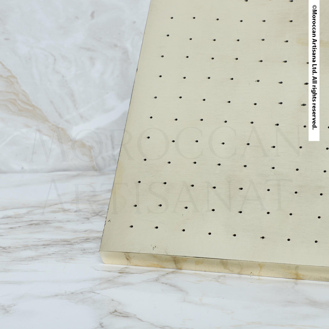 a close-up view of a white surface with a pattern of small holes or dots on it.