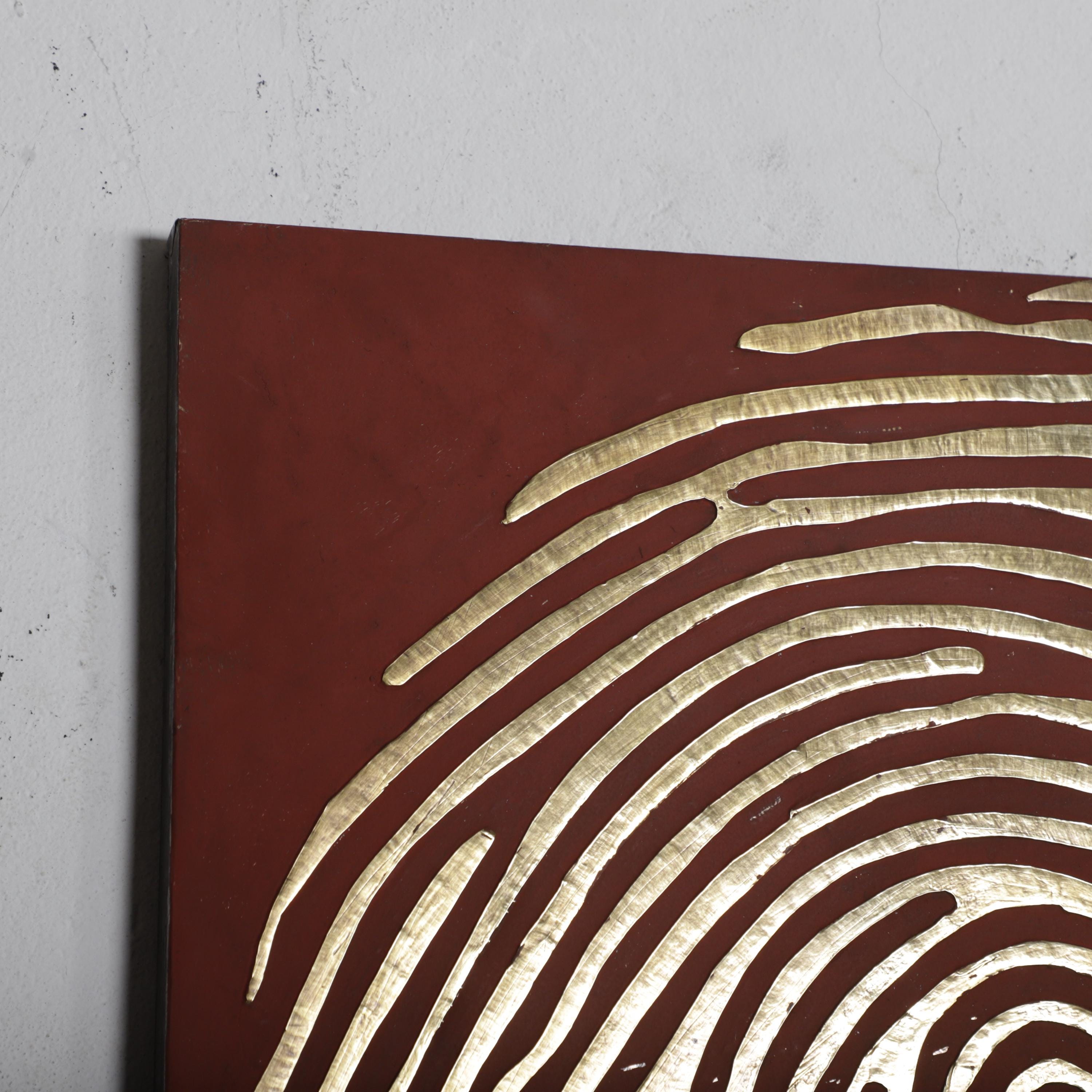 a close-up view of a red surface with a distinctive white, curved pattern resembling a fingerprint.