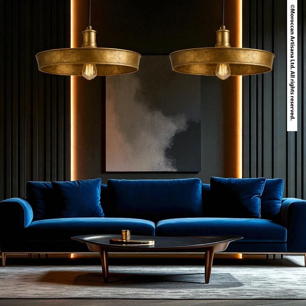 a luxurious living room with a blue velvet sofa, a wooden coffee table, and two gold pendant lights hanging above the sofa. The room has a dark color scheme with black walls and a gray rug, creating a sophisticated and elegant atmosphere.