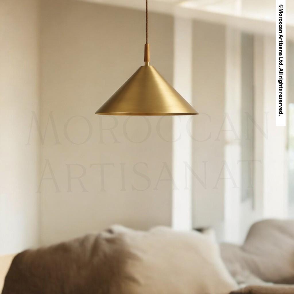 a modern, minimalist living room with a gold pendant lamp hanging from the ceiling, casting a warm glow over the space.