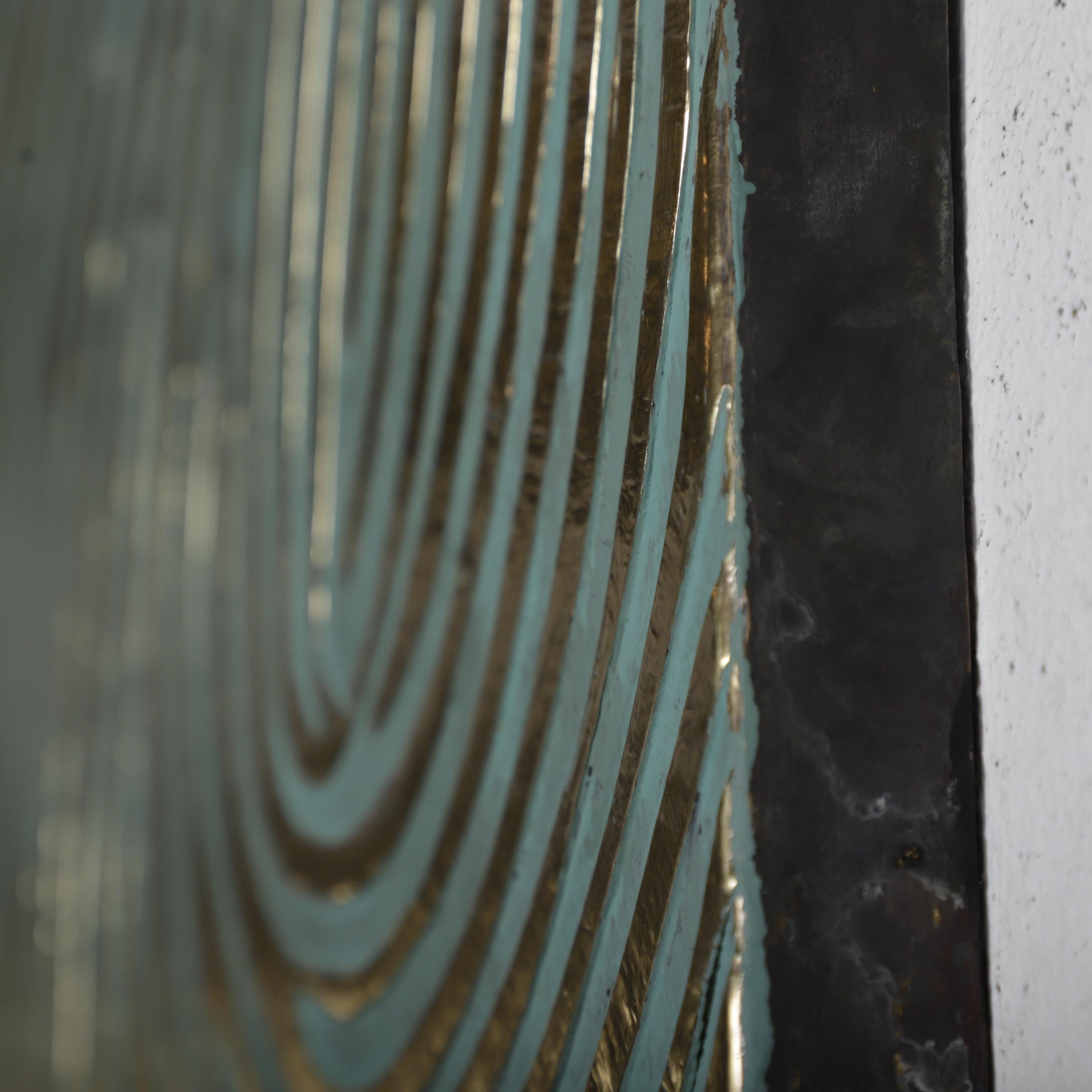 a close-up view of a textured surface with a repeating pattern of curved lines in shades of blue and gold.