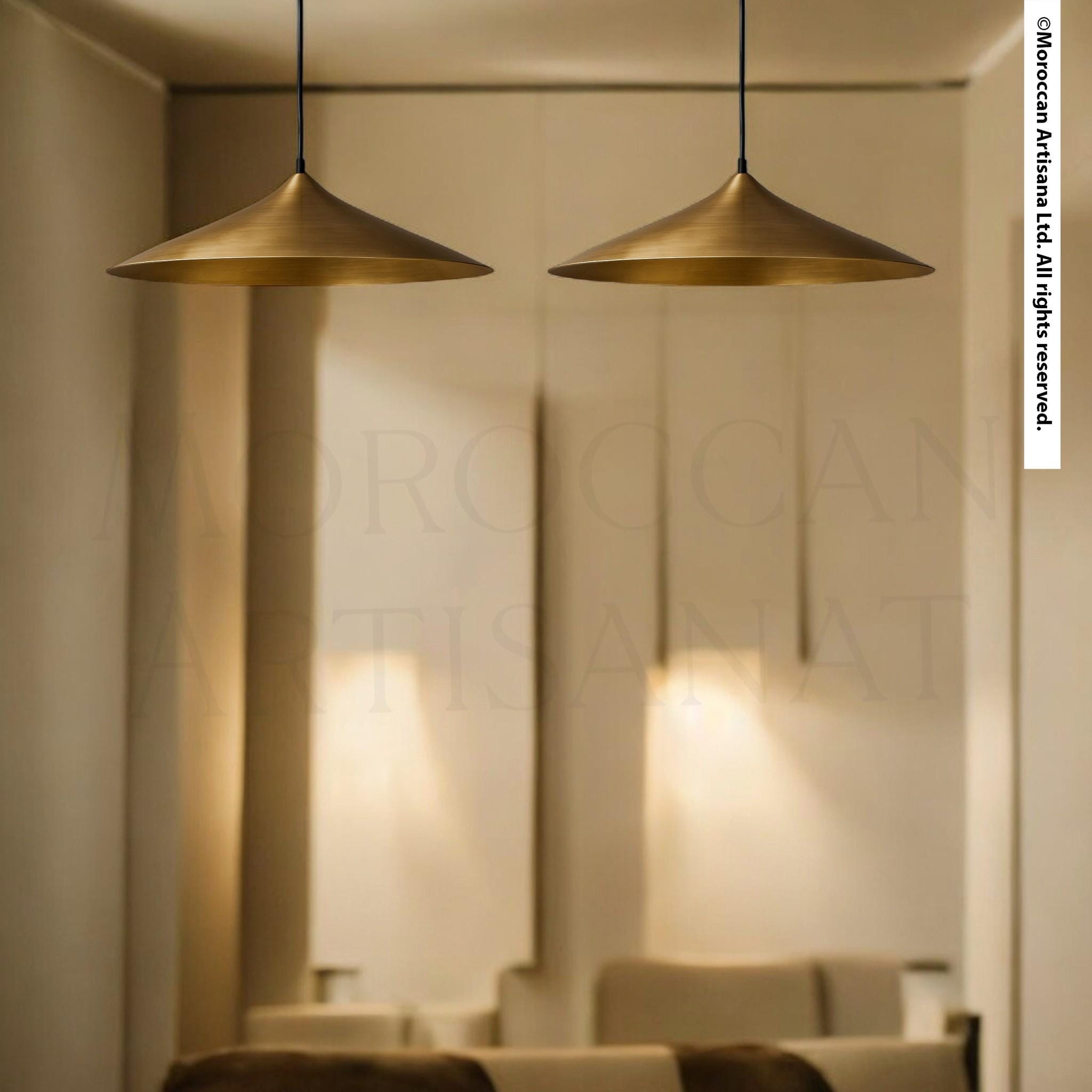 two gold pendant lights hanging from the ceiling, casting a warm glow in the room.