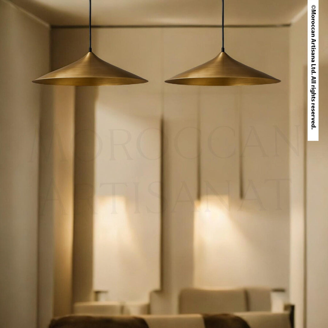 two gold pendant lights hanging from the ceiling, casting a warm glow in the room.