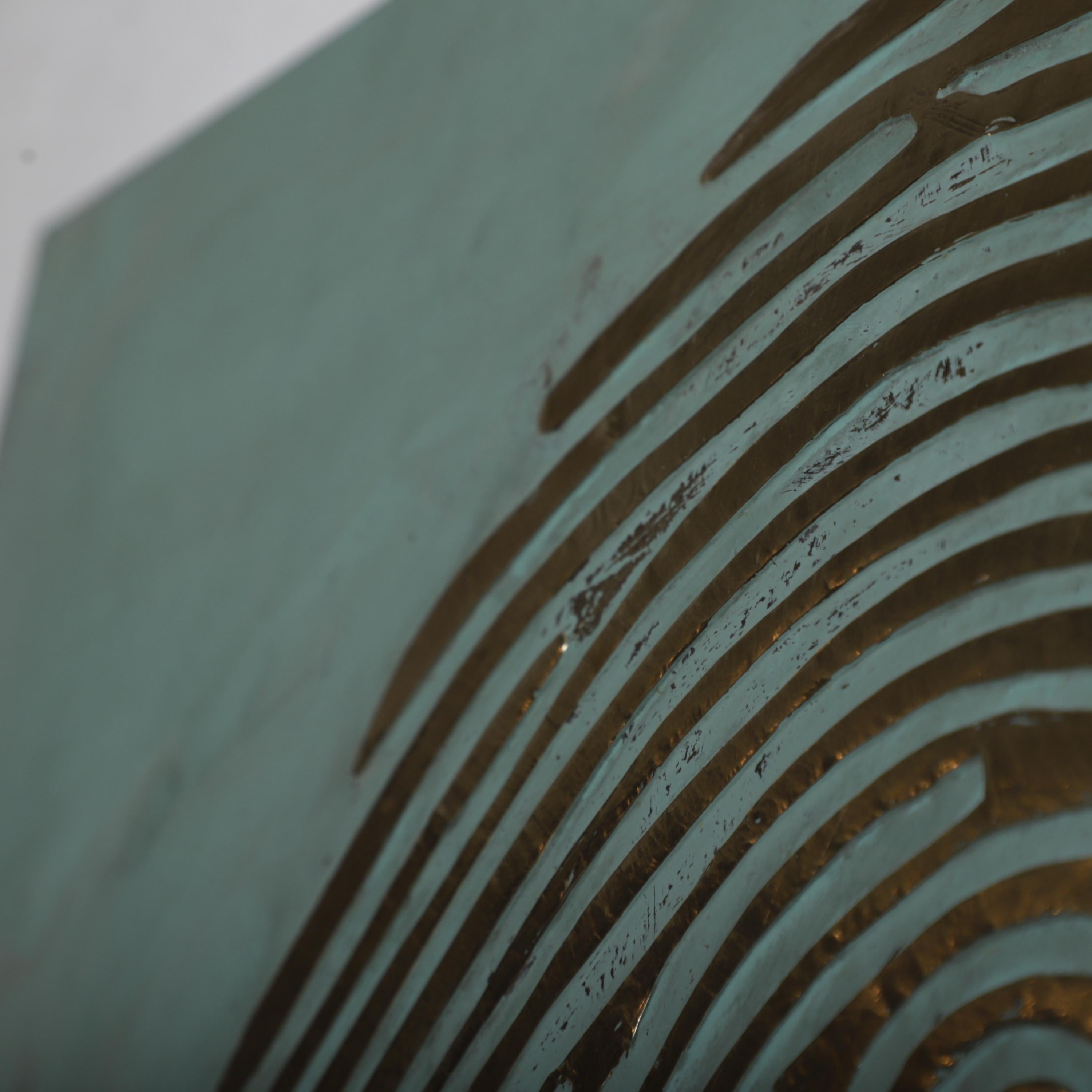 a close-up view of a textured surface with a repeating pattern of curved lines, resembling a fingerprint.