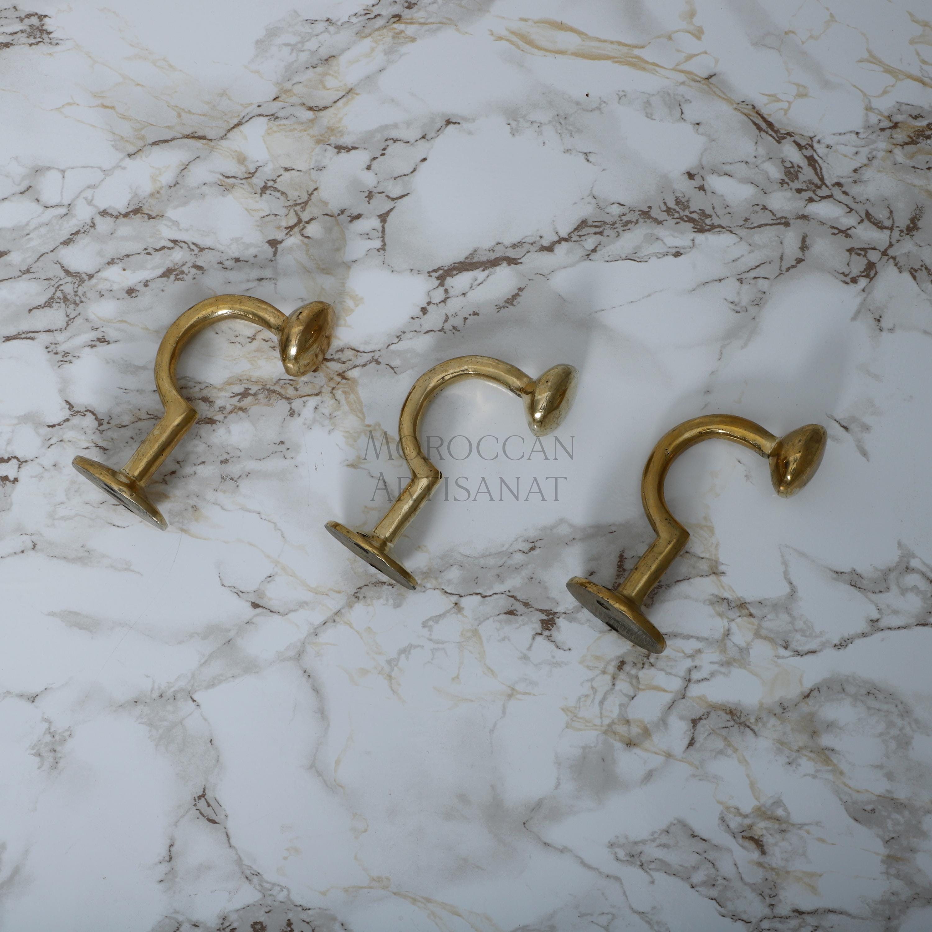 a marble counter top with two brass handles