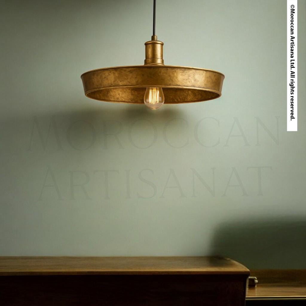 a modern, gold-colored pendant light hanging from the ceiling, casting a warm glow over the room.