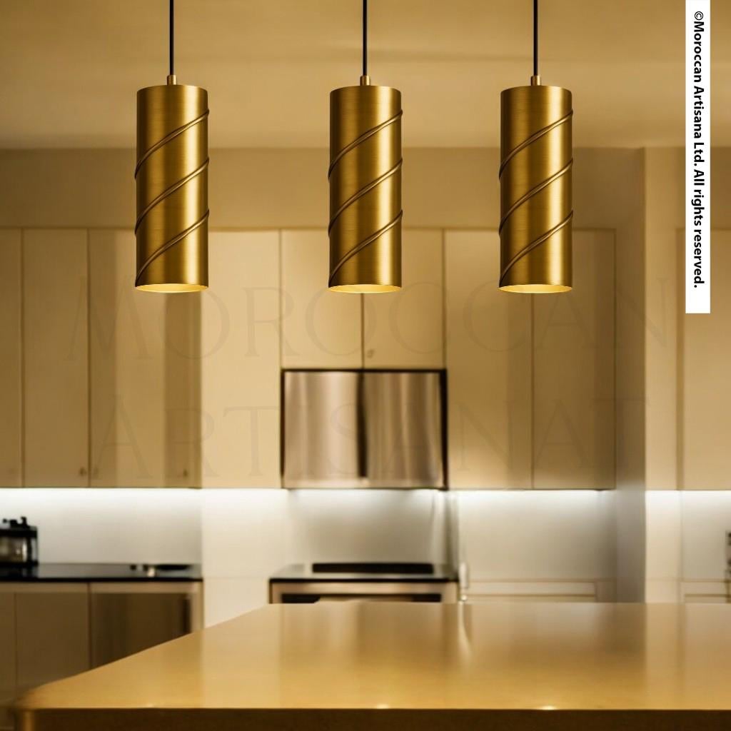 a modern kitchen with three pendant lights hanging above a countertop.