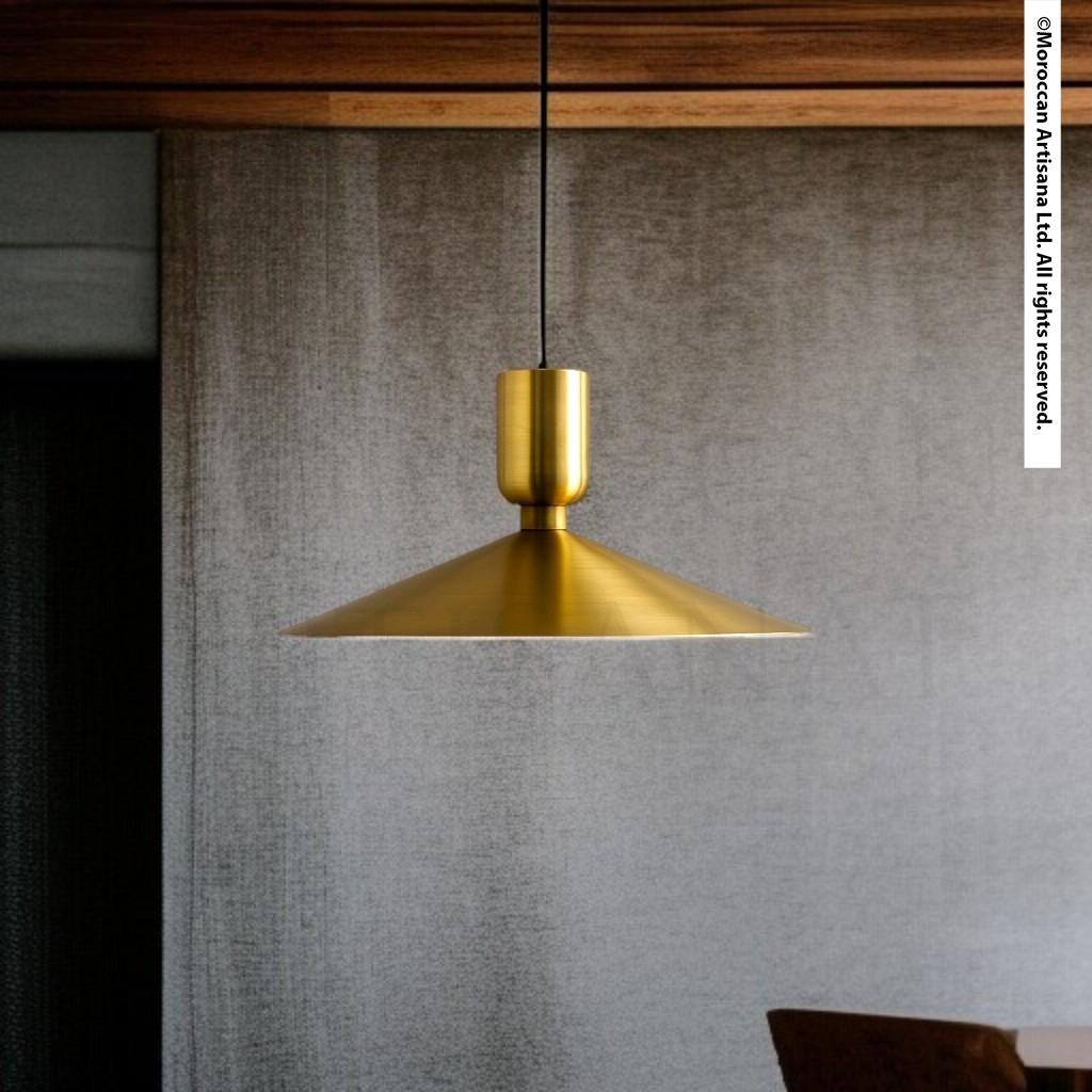 A modern, gold-colored pendant light hangs from the ceiling, casting a warm glow in the room.