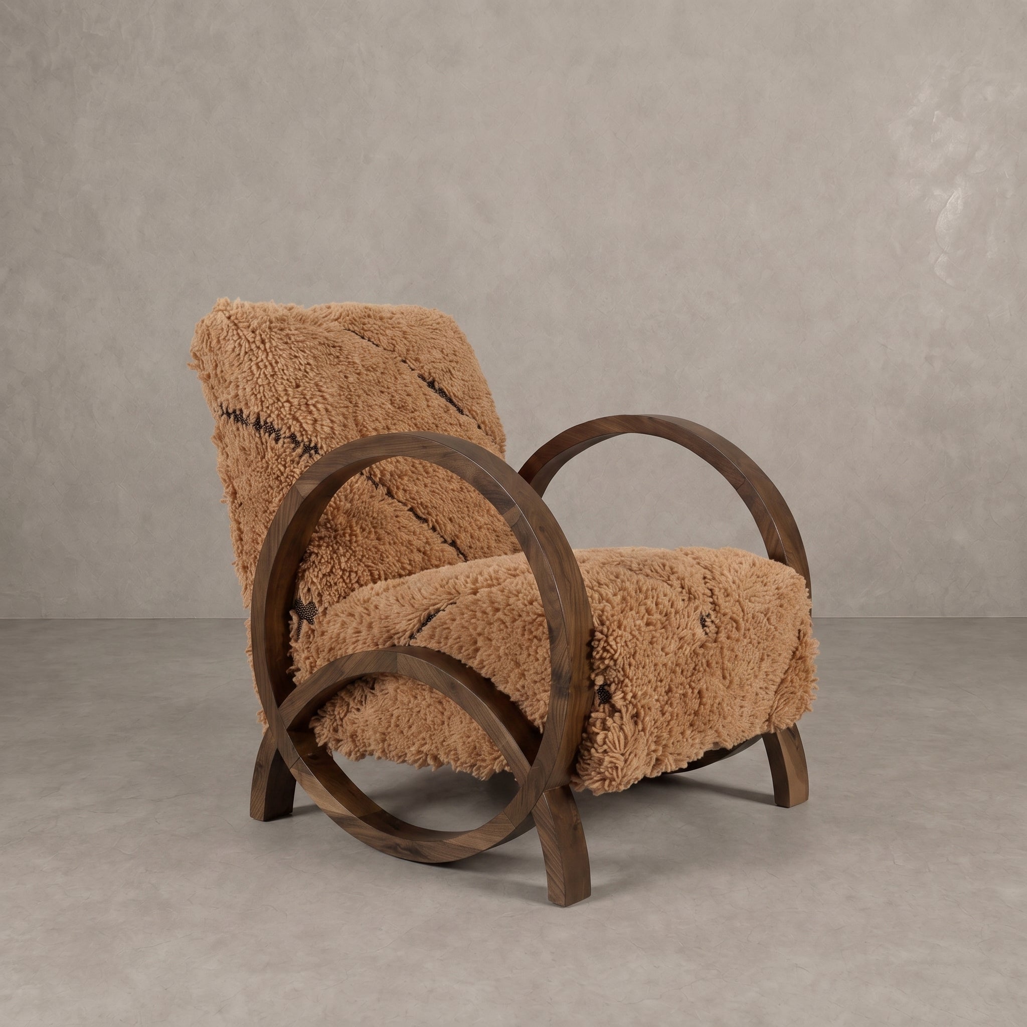 A rustic wooden armchair with a shaggy tan sheepskin-style seat and back cushion, set against a textured gray concrete wall and floor.