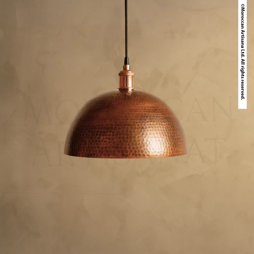 Hand-hammered copper dome pendant light with warm reflective finish, Moroccan artisan ceiling fixture for rustic or modern interiors