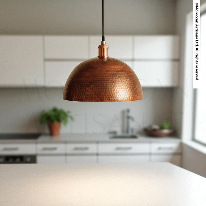Hand-hammered copper dome pendant light with warm reflective finish, Moroccan artisan ceiling fixture for rustic or modern interiors