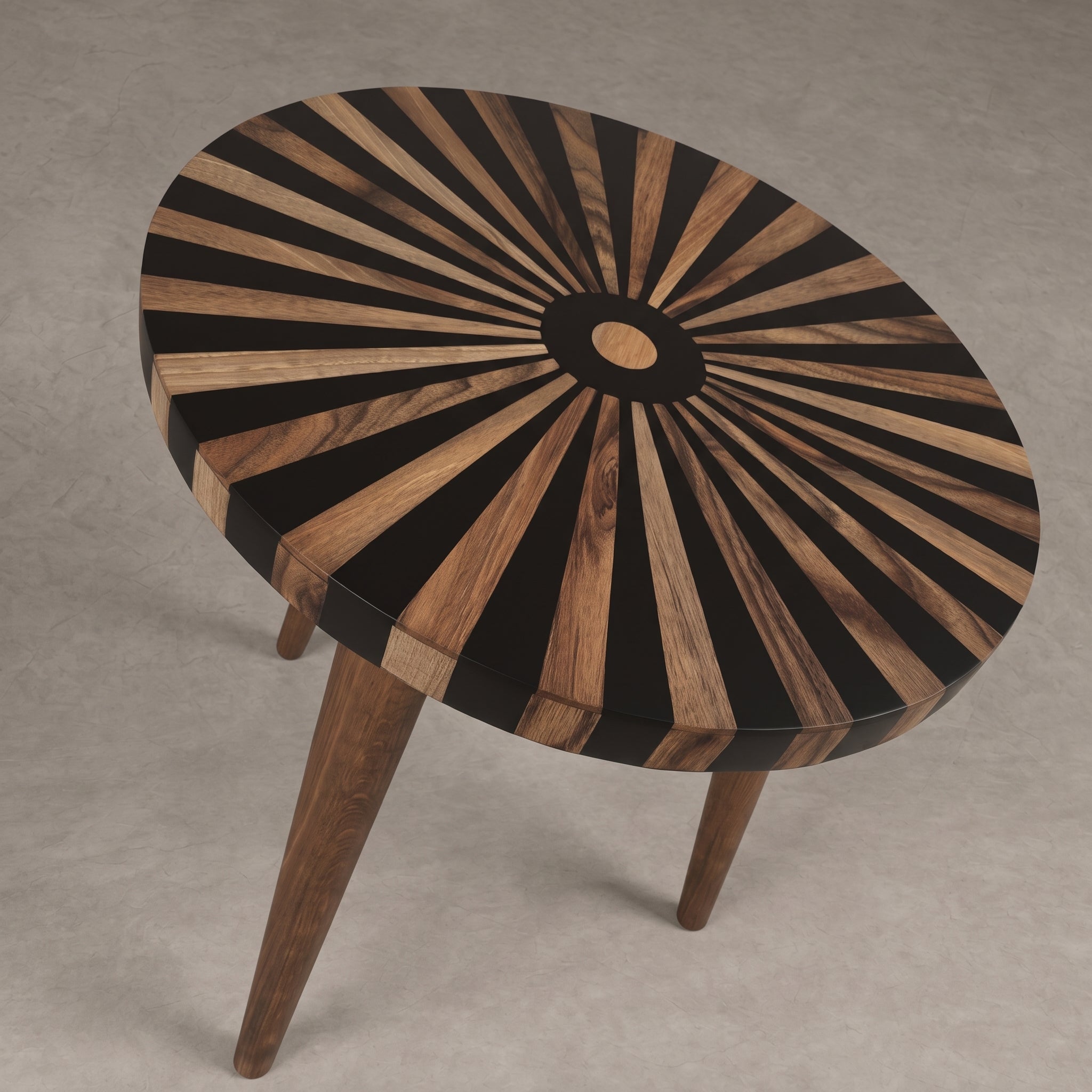 A round wooden side table with a sunburst inlay pattern on the top, featuring alternating black and warm brown wood rays radiating from a central circular detail, supported by three tapered wooden legs on a neutral gray background.