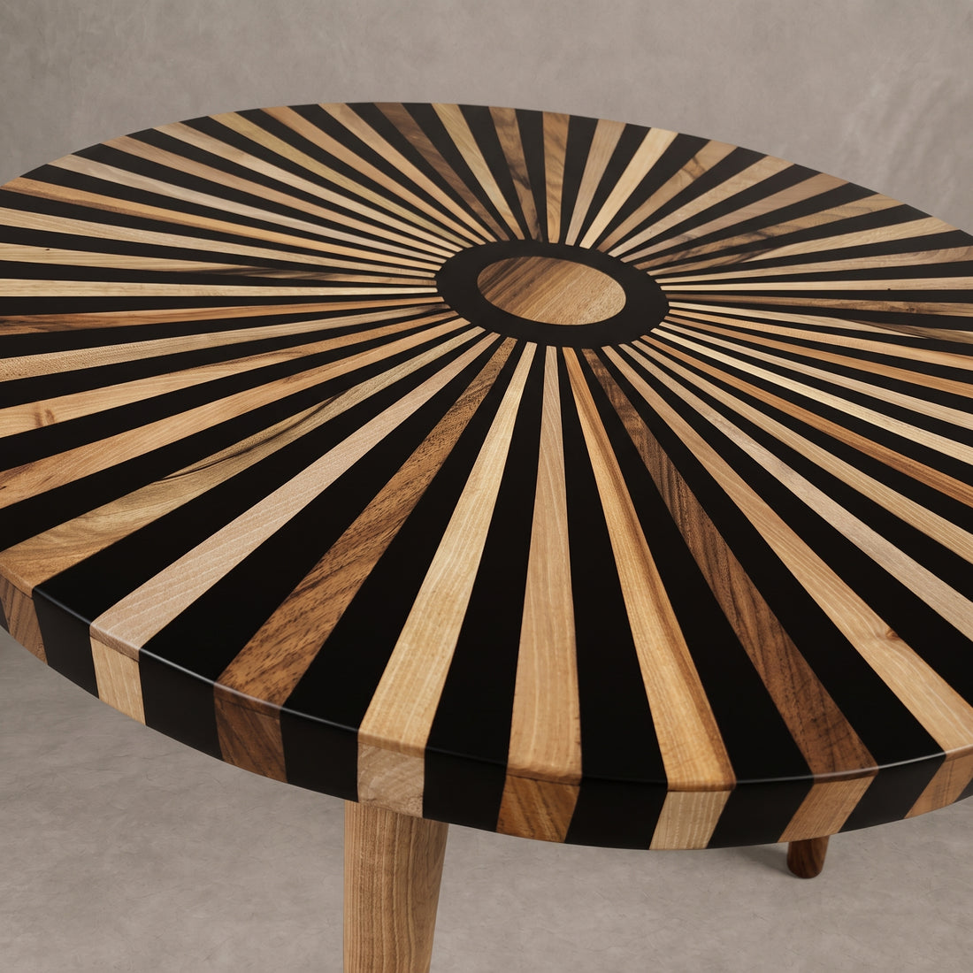A round wooden table top with a sunburst inlay pattern of alternating black and natural wood stripes, shown from a top-down angle on a neutral gray background.