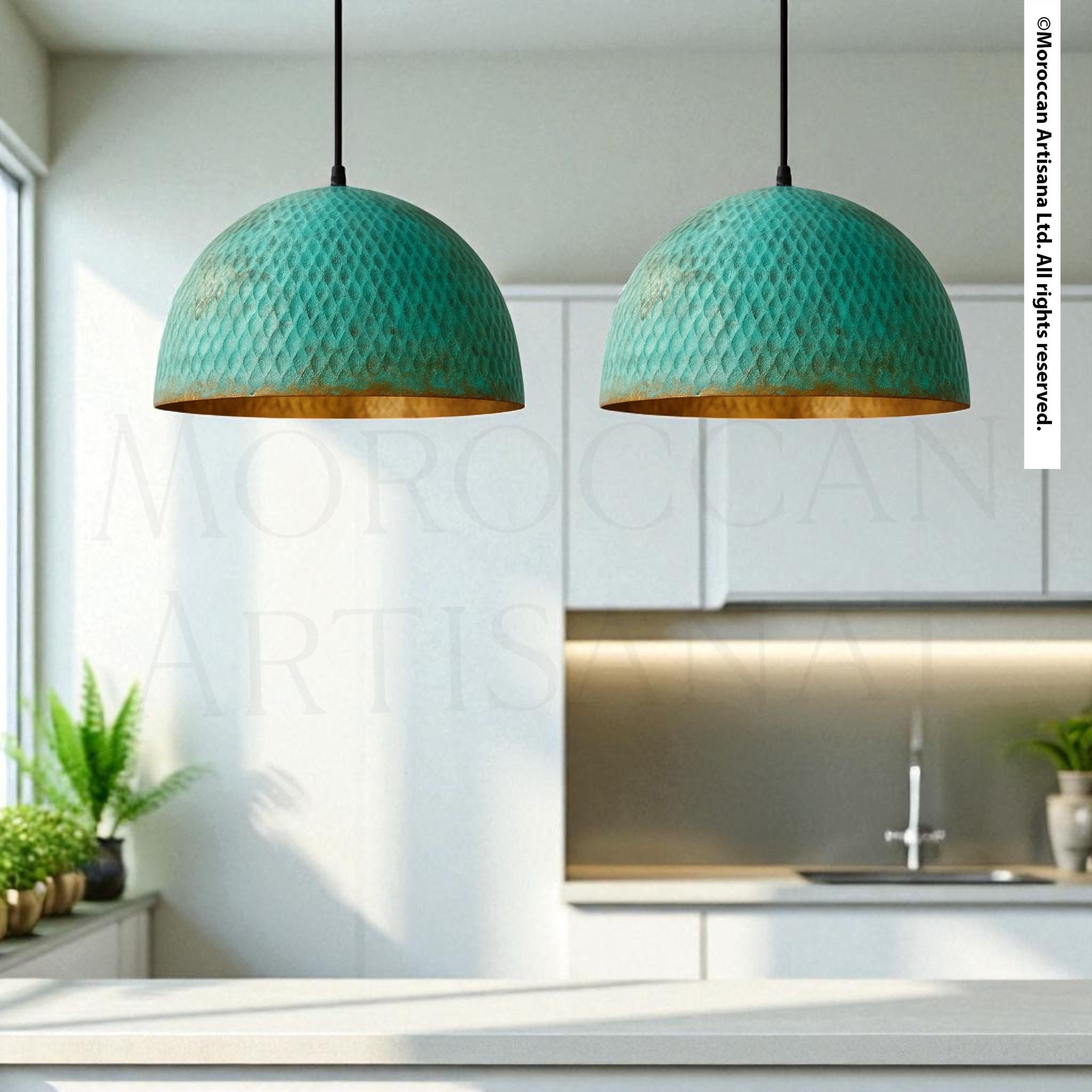 two green pendant lights hanging from the ceiling in a kitchen setting.