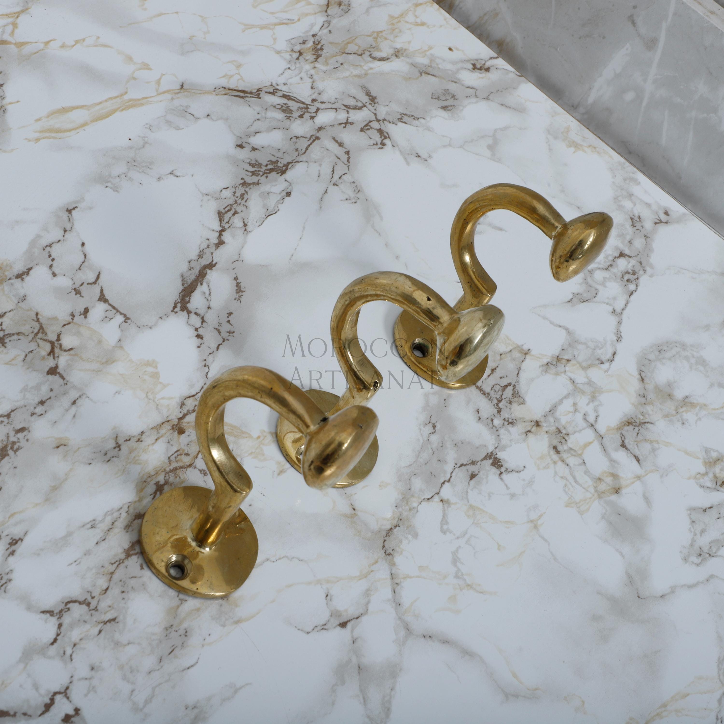 a marble counter top with brass handles on it