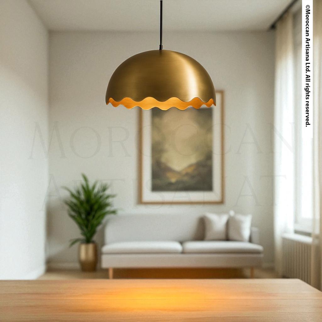 a modern living room with a large, gold-colored pendant light hanging from the ceiling, casting a warm glow over the space. In the background, there is a white sofa and a framed landscape painting on the wall.