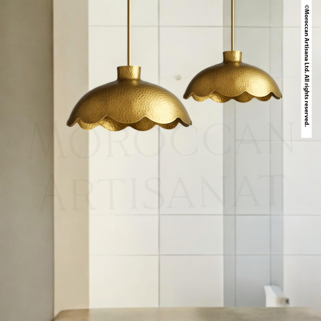 two gold-colored scalloped pendant lights hanging from the ceiling.