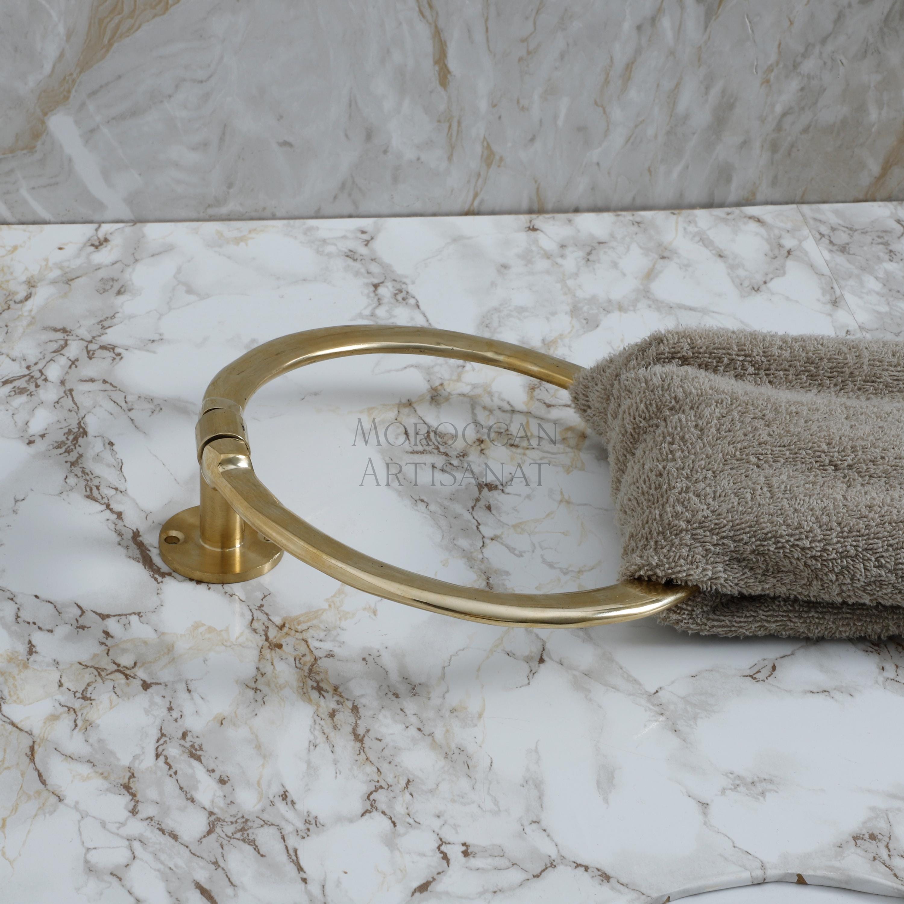 a towel and a towel ring on a marble counter