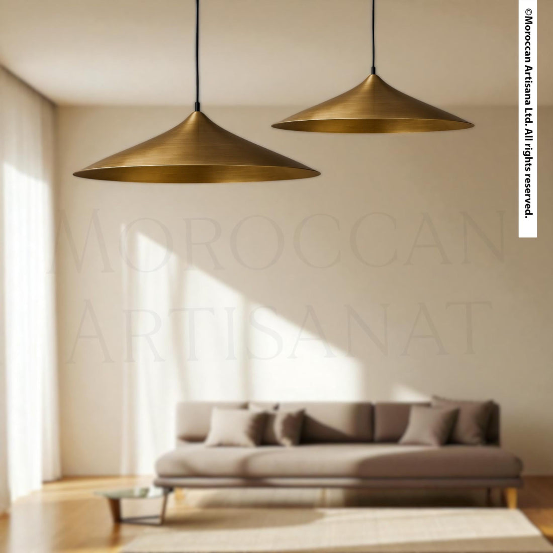 a modern living room with a gray sofa and two pendant lights hanging above it.