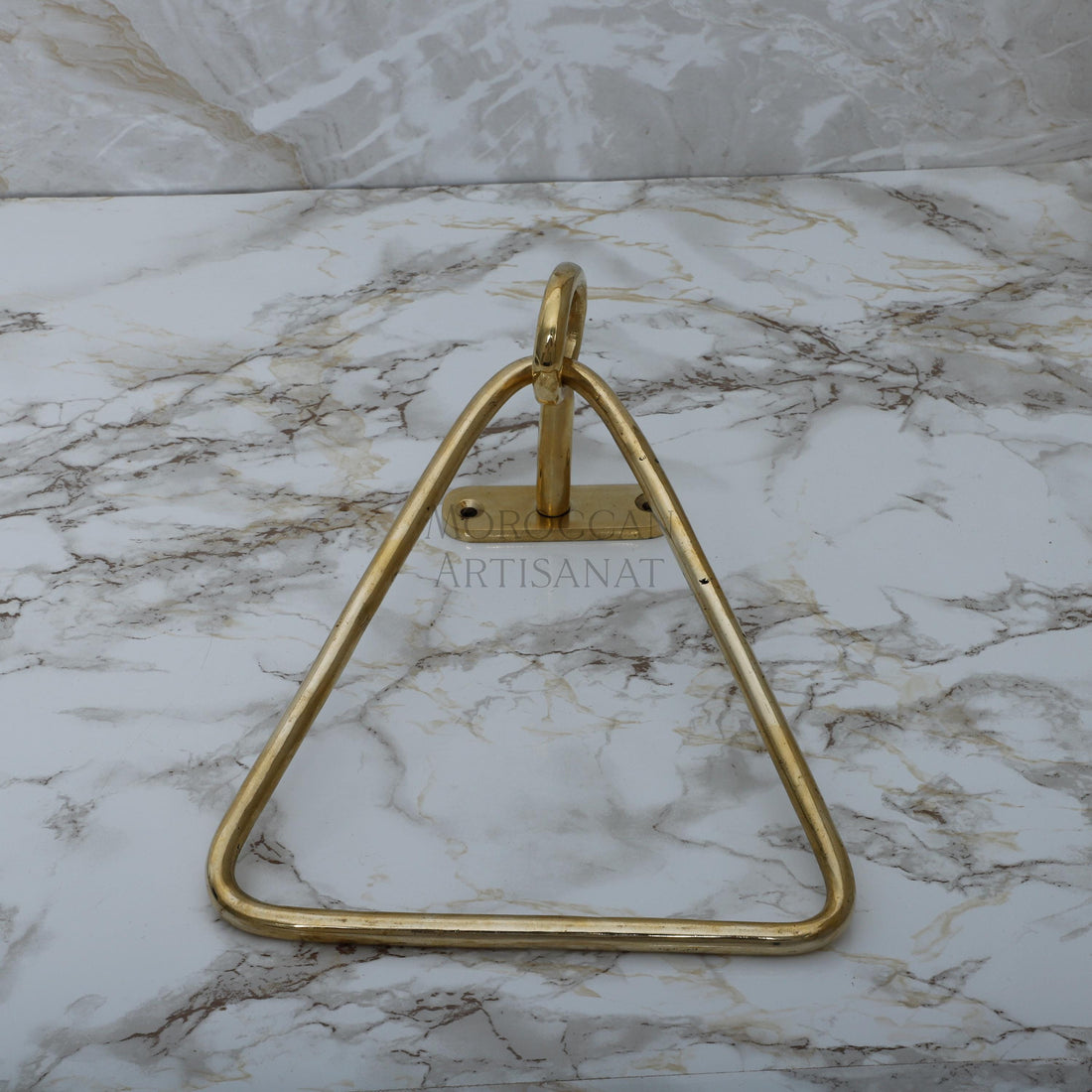 a marble counter top with a metal triangle on it