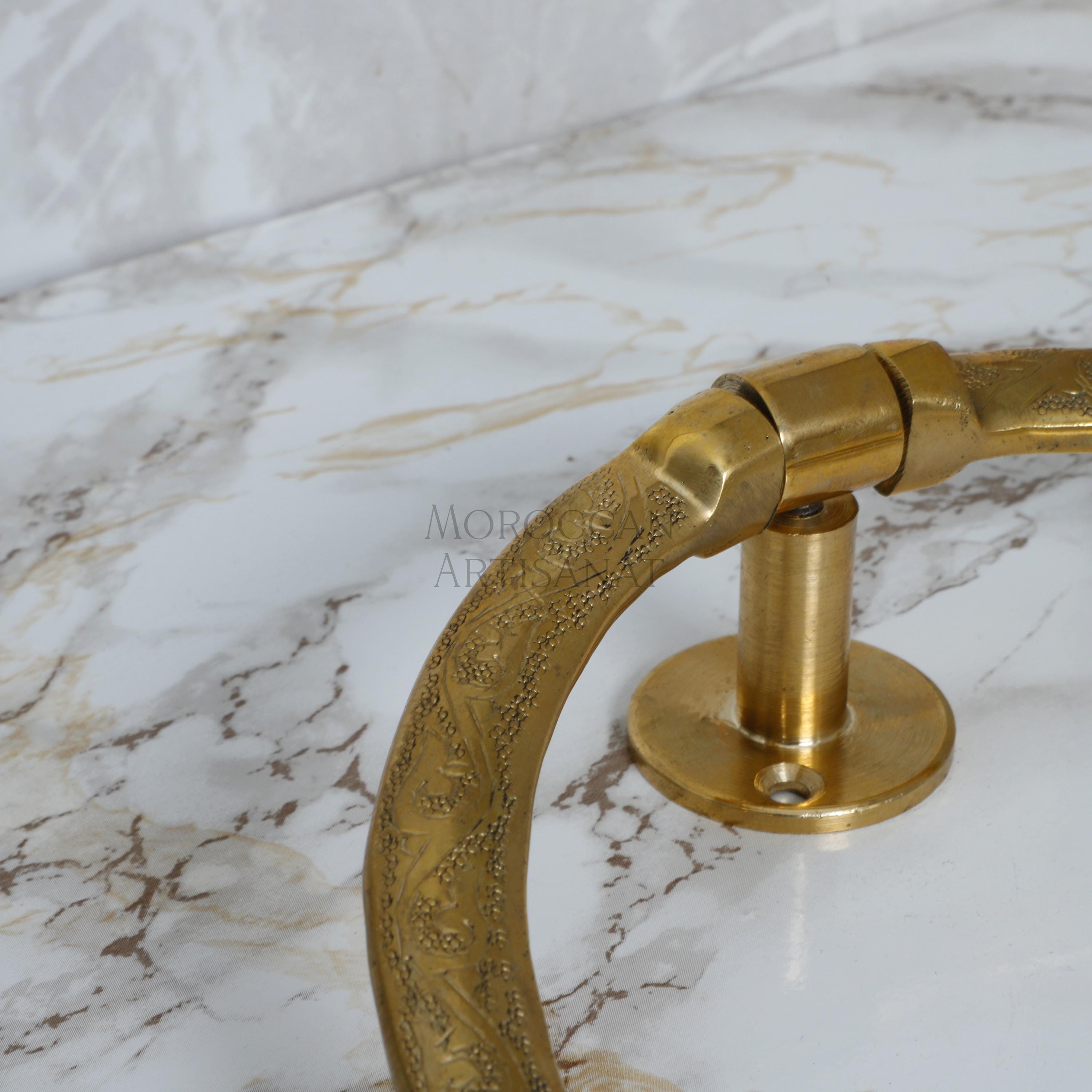 a gold handle on a marble counter top