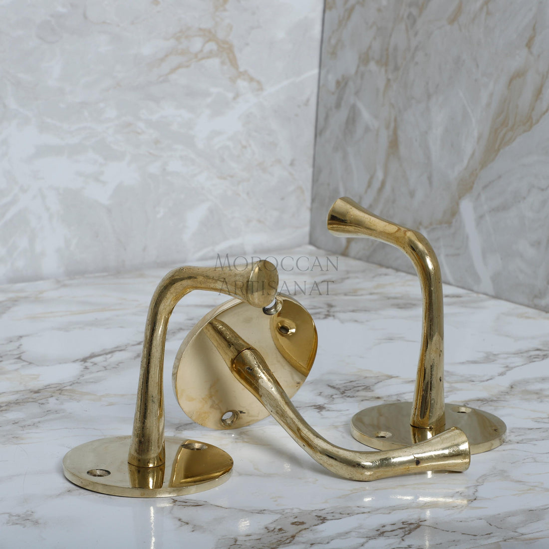 a bathroom sink with a gold faucet and marble counter top