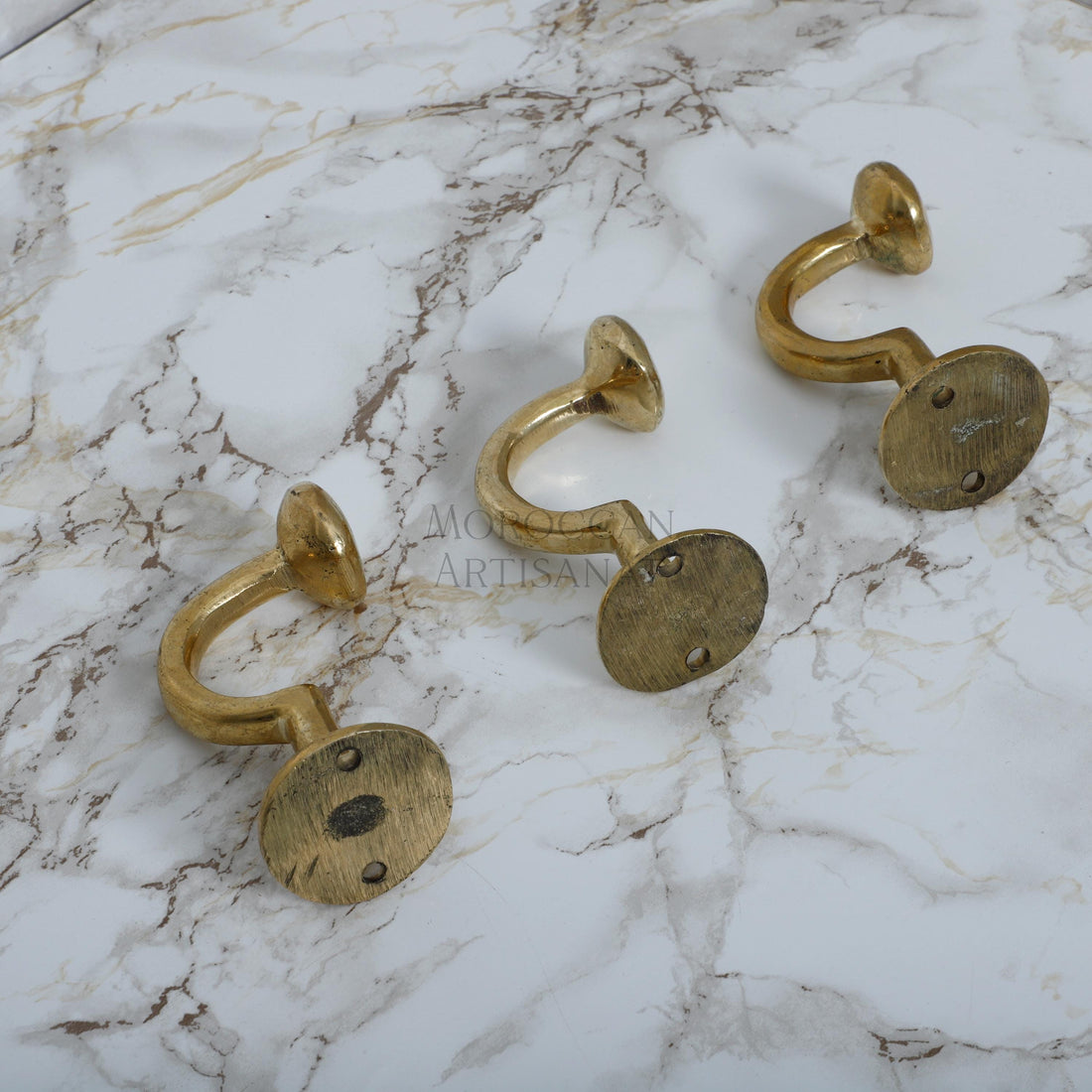 a marble table topped with three gold rings
