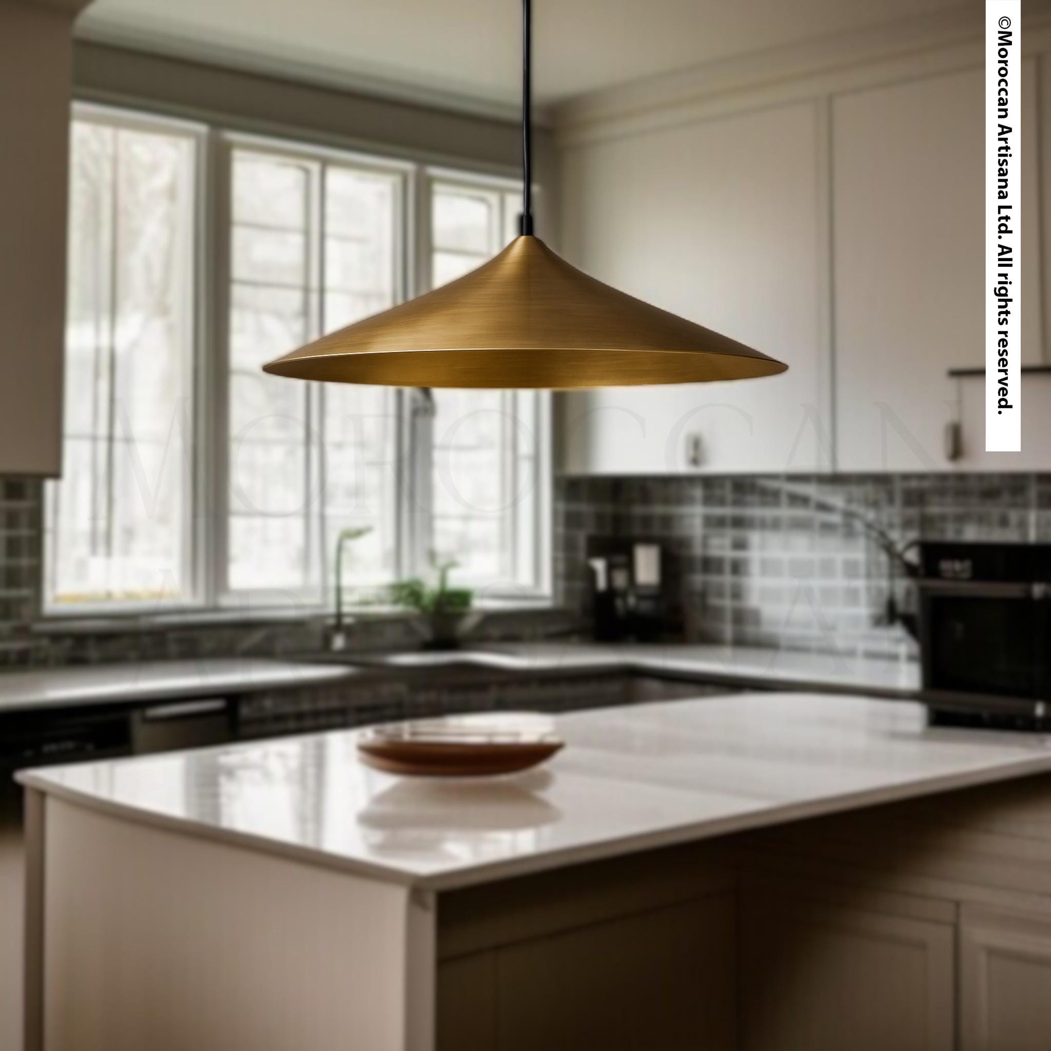 a modern kitchen with a pendant light hanging above a white countertop. The kitchen has white cabinets and a tiled backsplash, creating a clean and minimalist aesthetic.