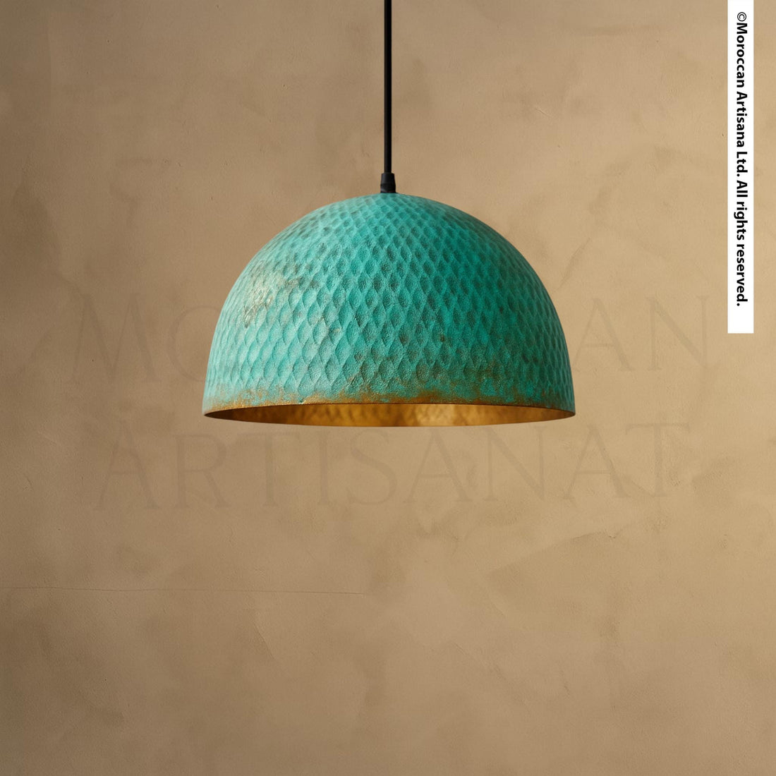 A turquoise-colored pendant lamp with a gold-colored shade hangs from the ceiling against a beige wall.