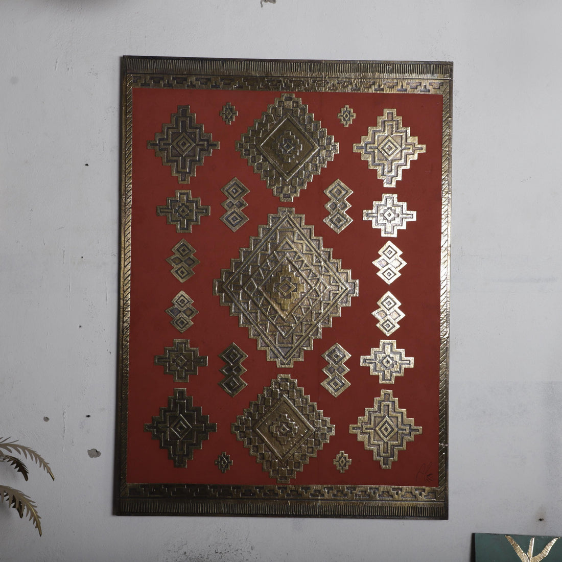 a red and gold geometric pattern with diamond shapes, arranged in a grid-like fashion.