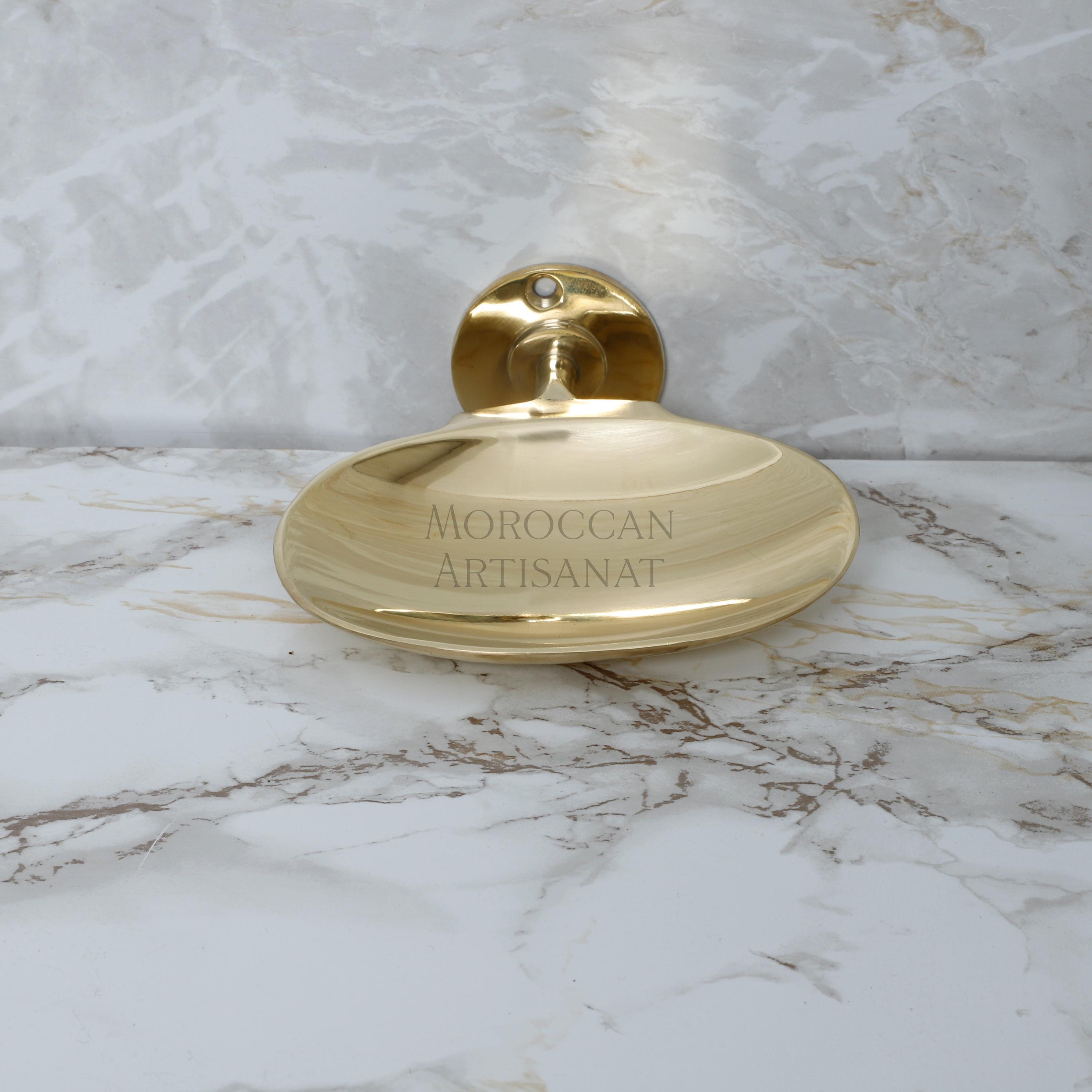 a marble counter top with a gold plate on it
