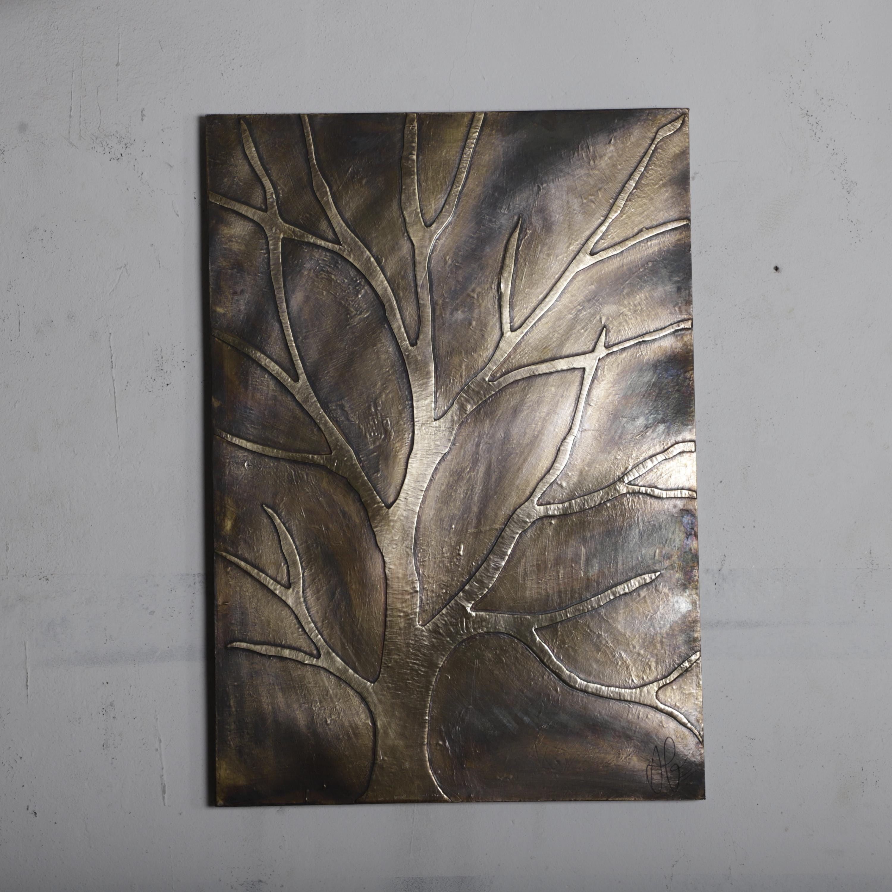 a large, metallic tree-like design on a wall.