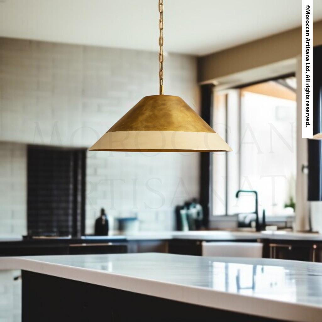 a modern kitchen with a large pendant light hanging above a marble countertop.