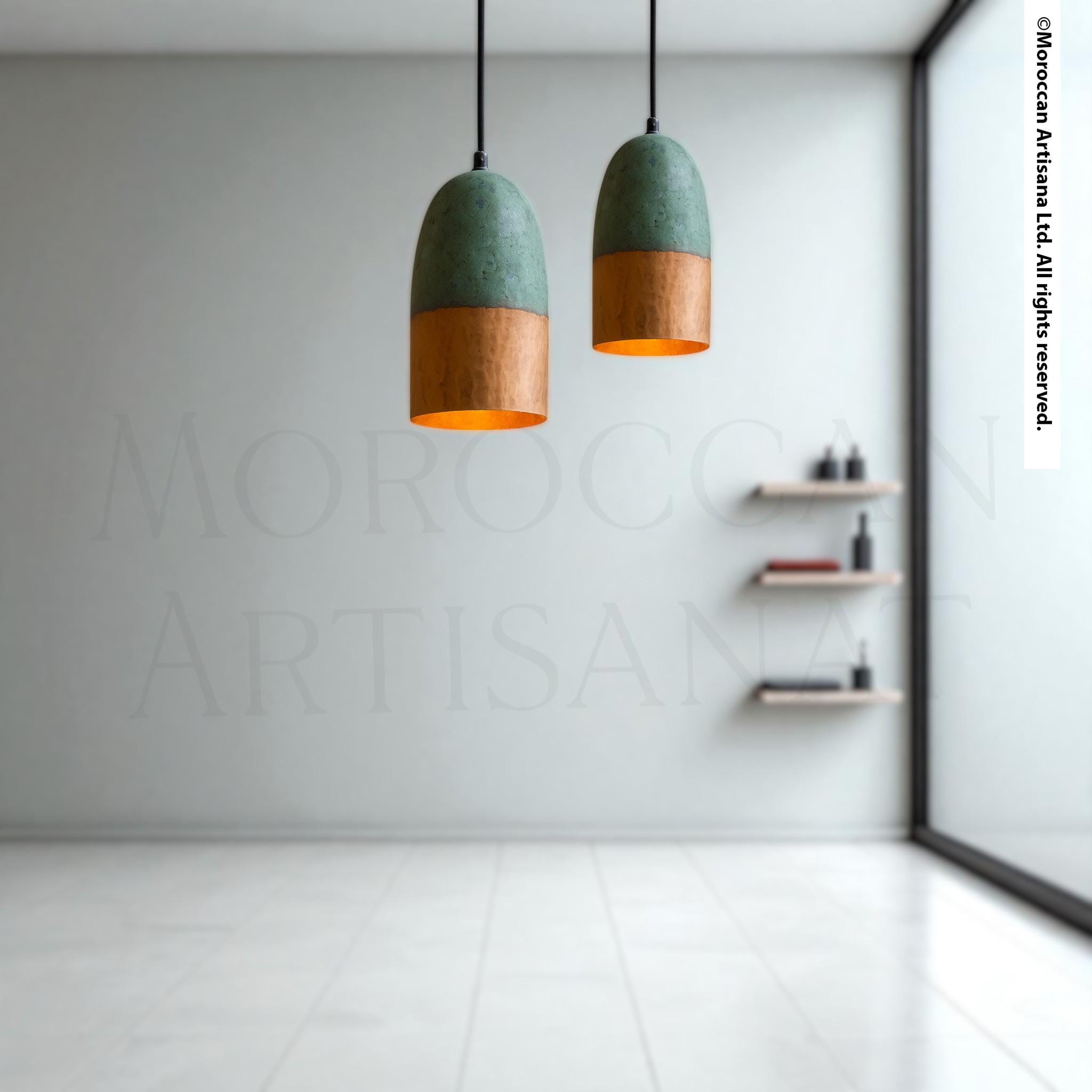 two pendant lights hanging from the ceiling in a minimalist room with white walls and a tiled floor.