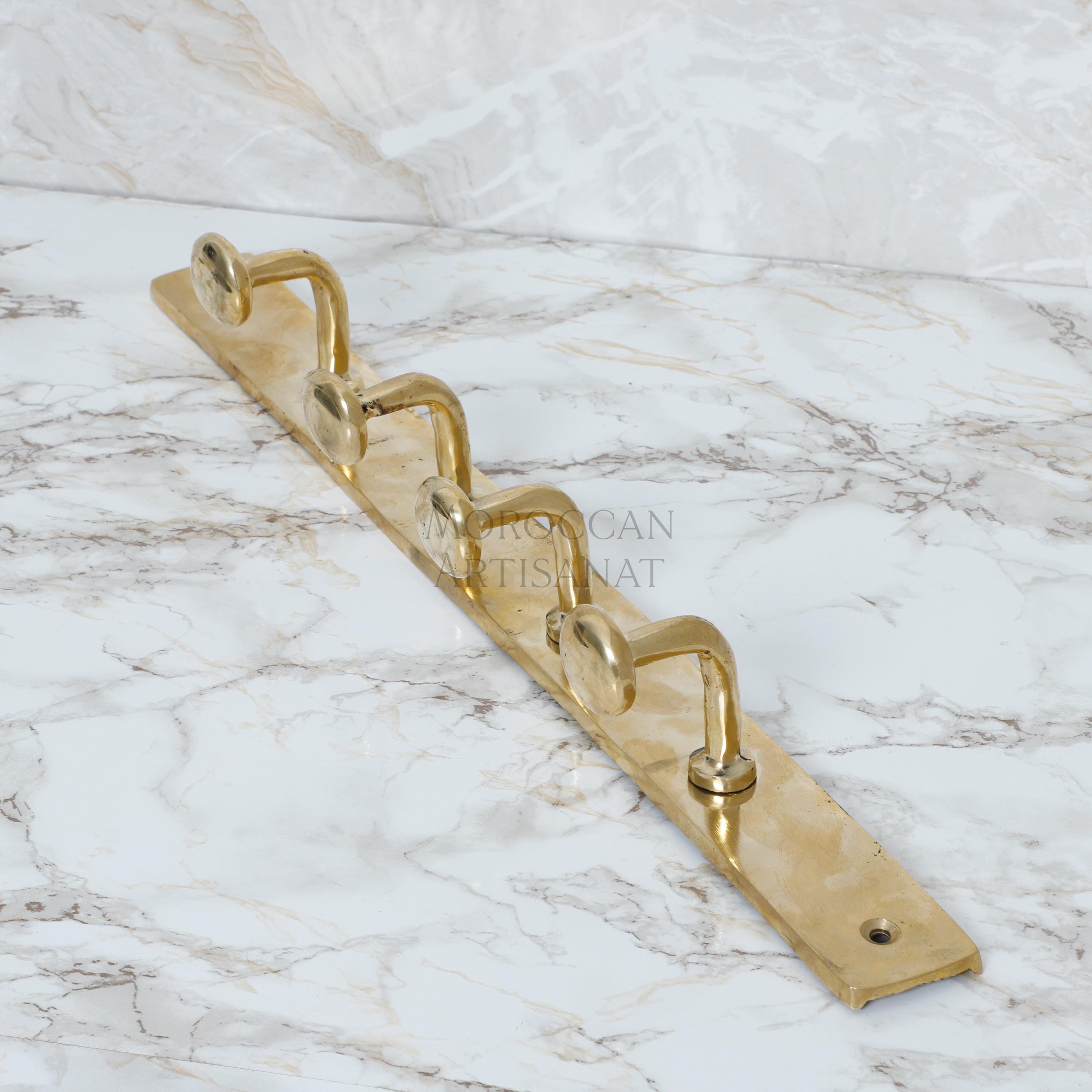 a golden metal hook on a marble surface