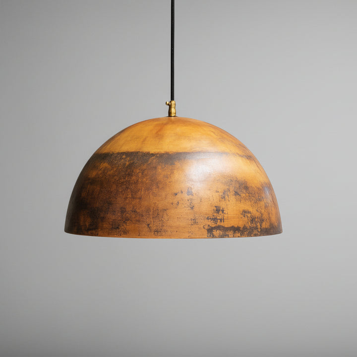 A rustic, wooden pendant lamp with a warm, earthy tone hangs from the ceiling against a neutral background.