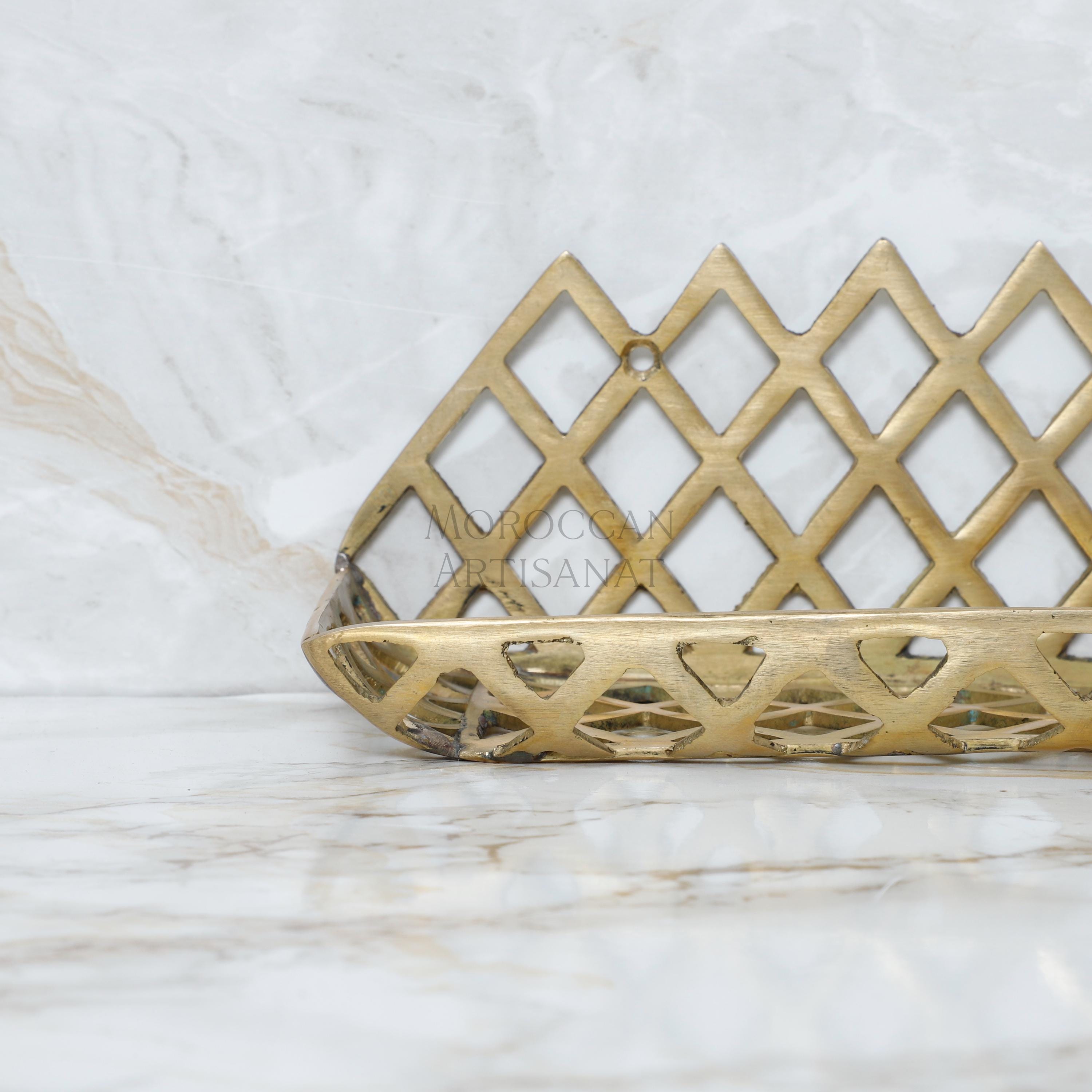 a gold decorative object sitting on a marble surface