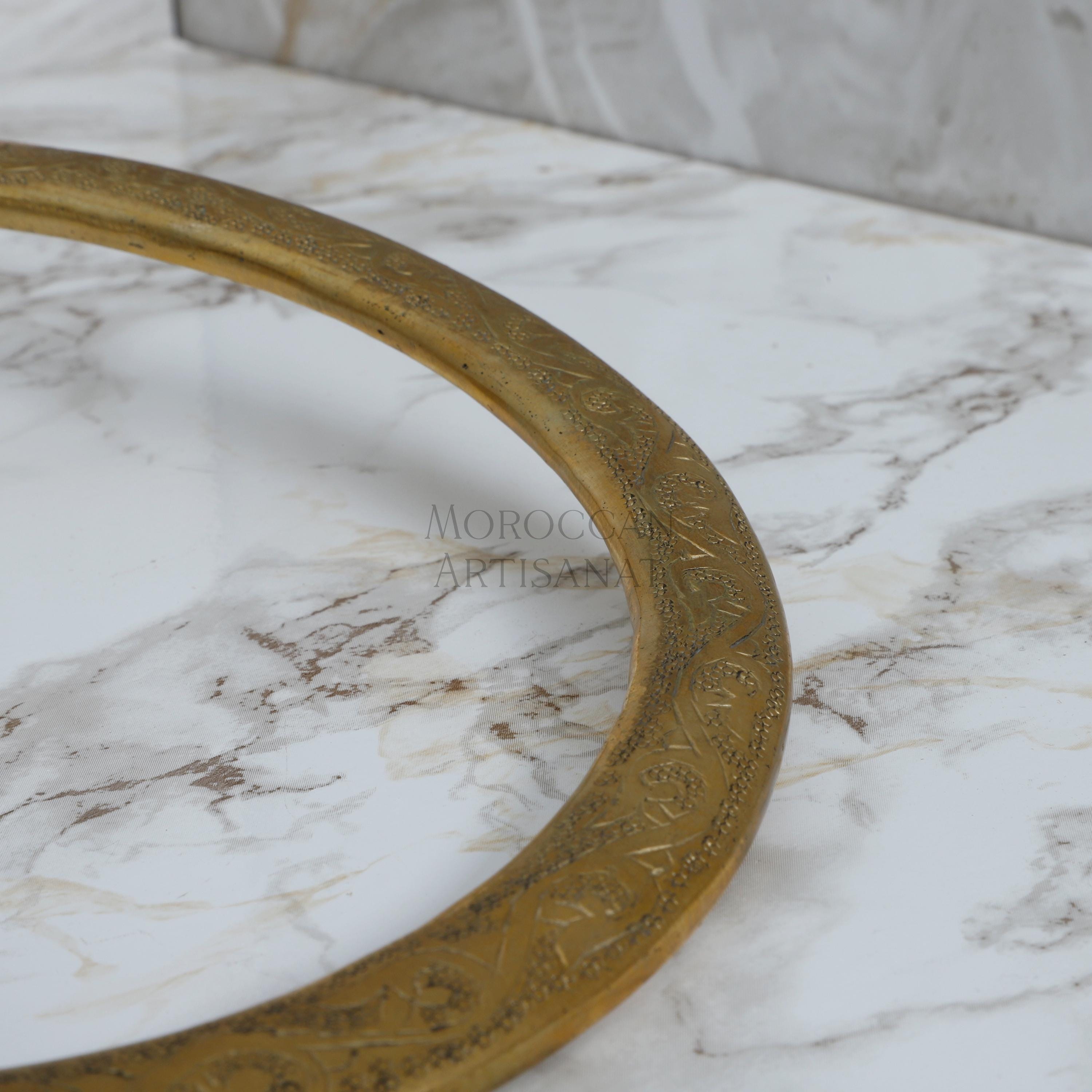 a close up of a marble counter top with a gold ring