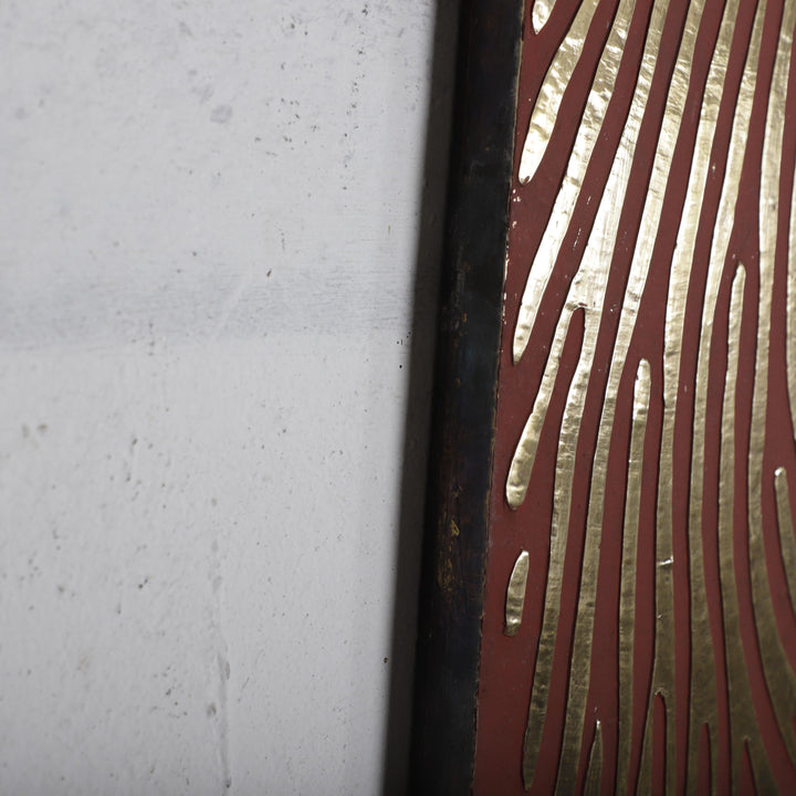 a close-up view of a white wall with a red stripe running along it. The red stripe has a unique zebra-like pattern, adding a distinctive visual element to the scene.