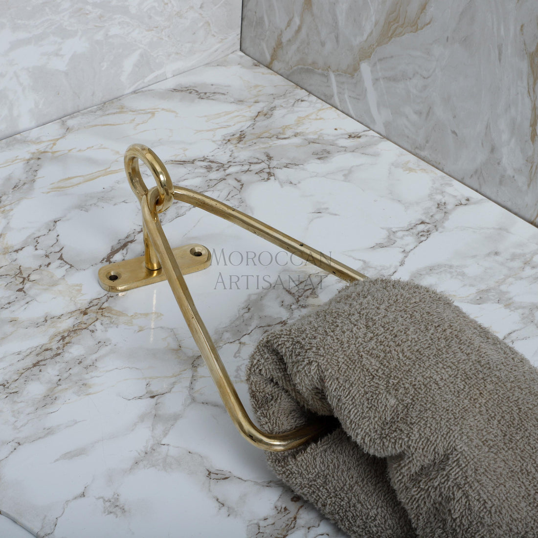 a pair of gloves and a towel rack on a marble counter